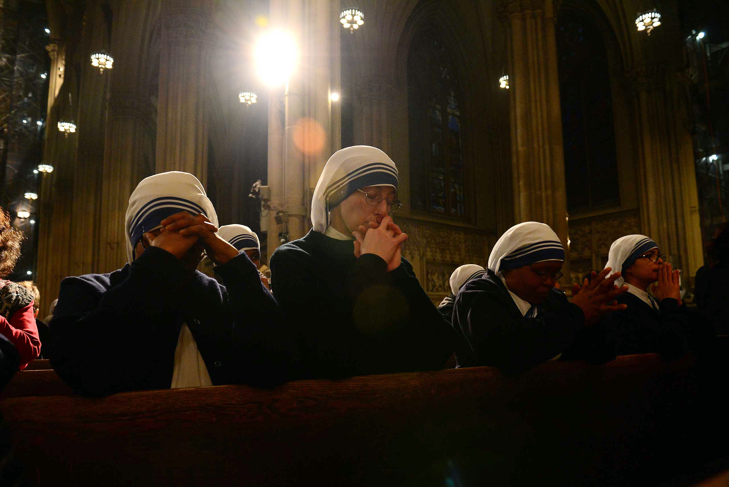 Nuns pray during a mass in celebration of Pope Benedict XVI at St. Patrick's Cathedral in New York, Feb. 28, 2013. (Emmanuel Dunand—AFP/Getty Images)
