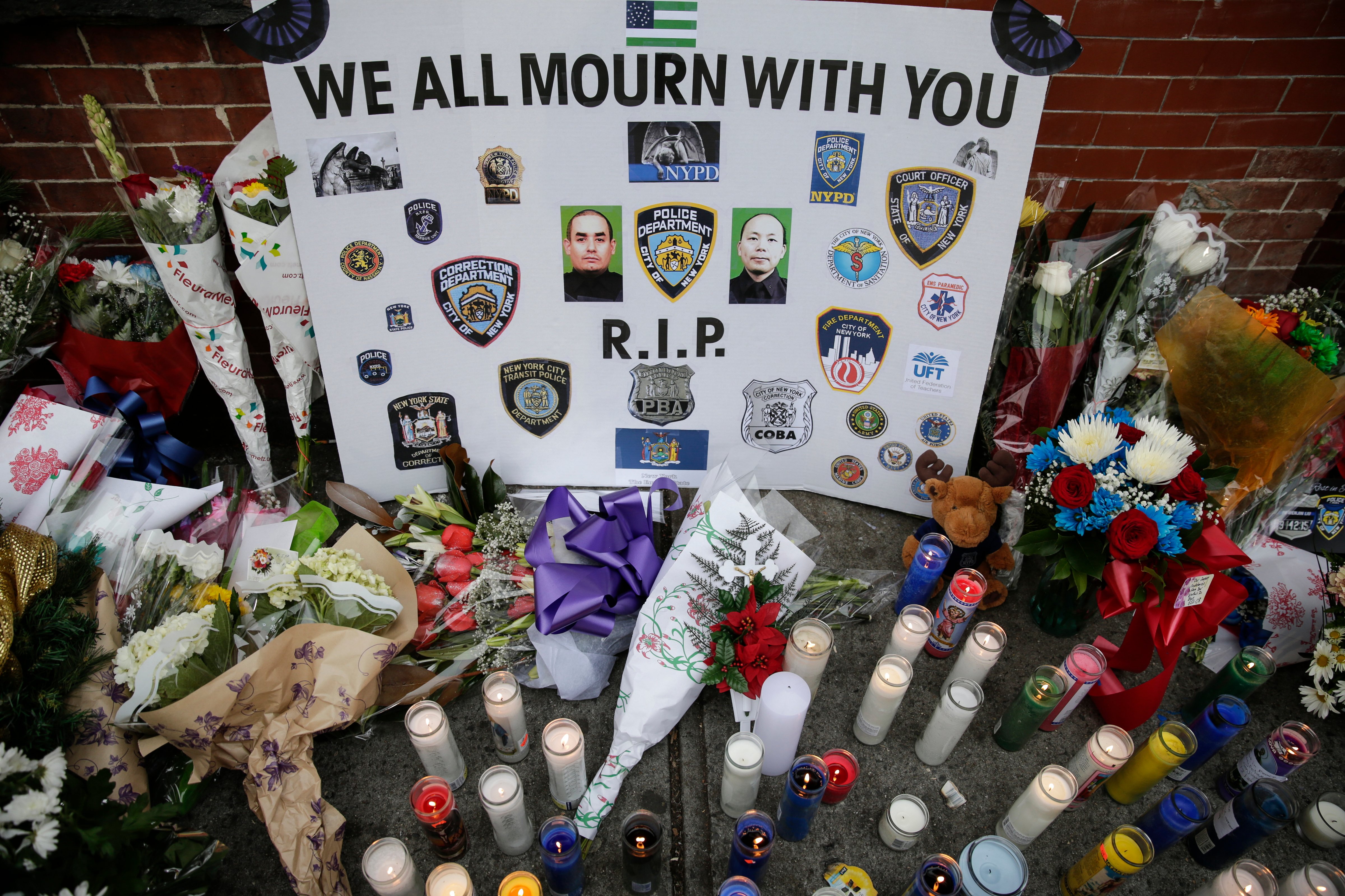 A view of the memorial for slain NYPD officers, Wenjian Liu and Rafael Ramos, on Tompkins Ave. and Myrtle Ave. where two officers were murdered, in Brooklyn, N.Y. on Dec. 22, 2014. (Bilgin Sasmaz—Anadolu Agency/Getty Images)