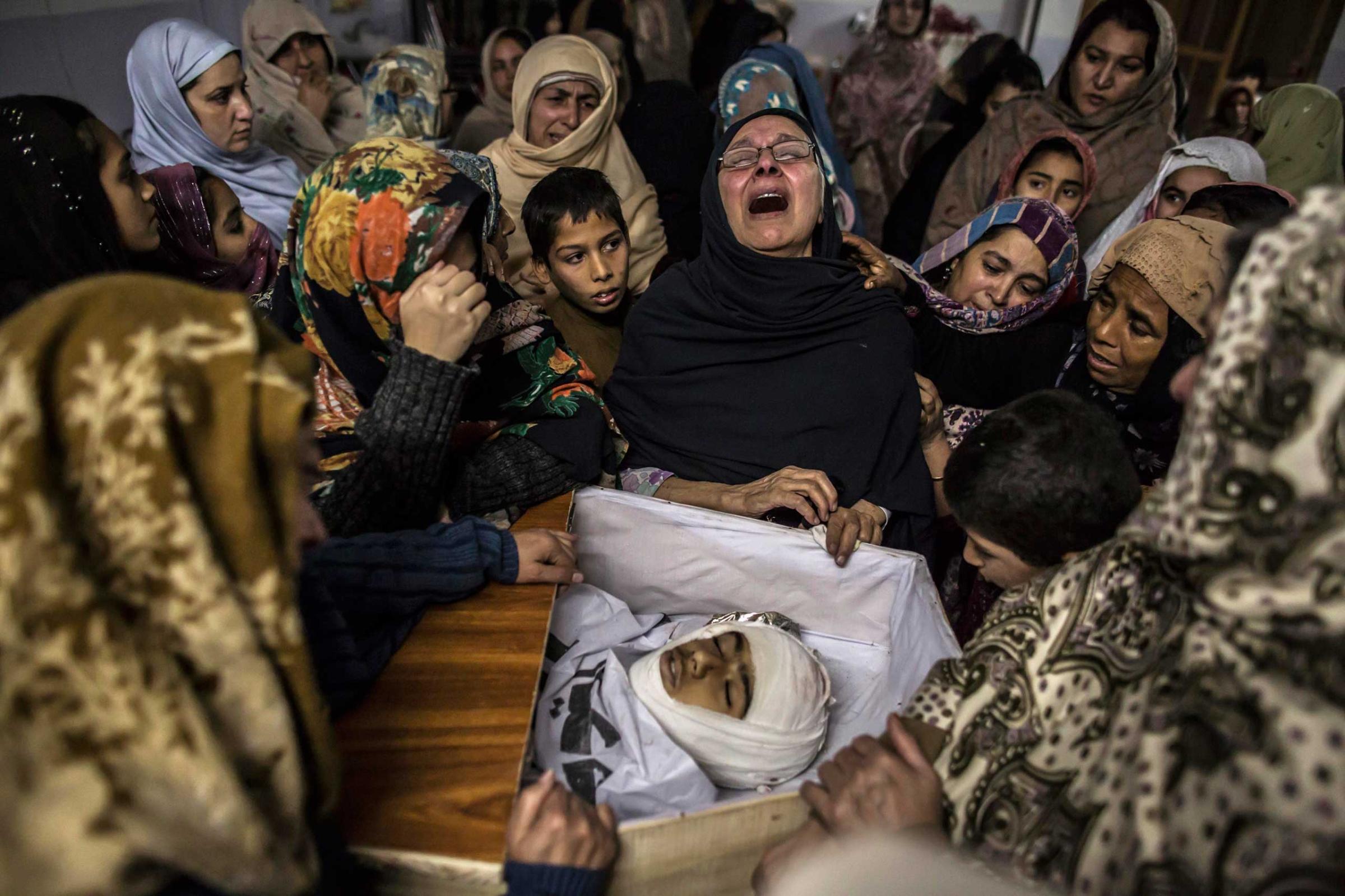 Women mourn their relative Mohammed Ali Khan, 15, a student who was killed during an attack by Taliban gunmen on the Army Public School, at his house in Peshawar, Dec. 16, 2014.