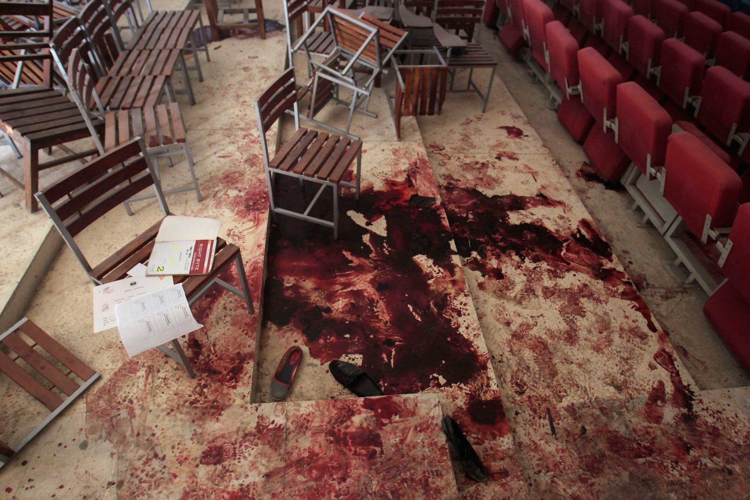 Shoes lie in blood on the auditorium floor at the Army Public School, which was attacked by Taliban gunmen, in Peshawar, Dec. 17, 2014.