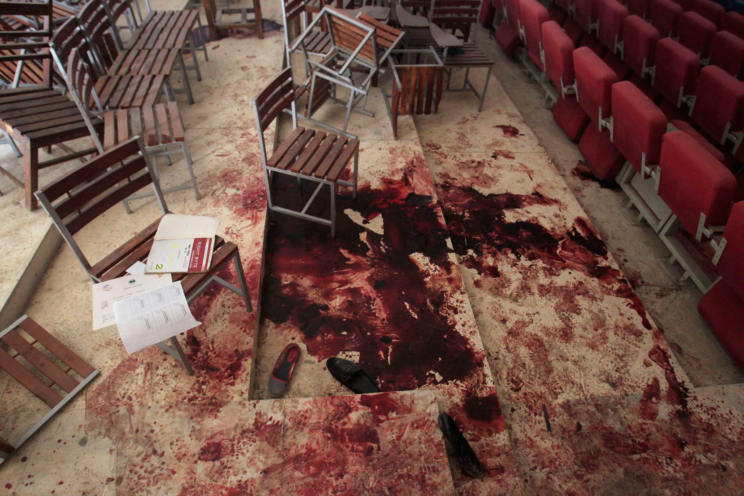 Shoes lie in blood on the auditorium floor at the Army Public School, which was attacked by Taliban gunmen, in Peshawar, Dec. 17, 2014. (Fayaz Aziz—Reuters)