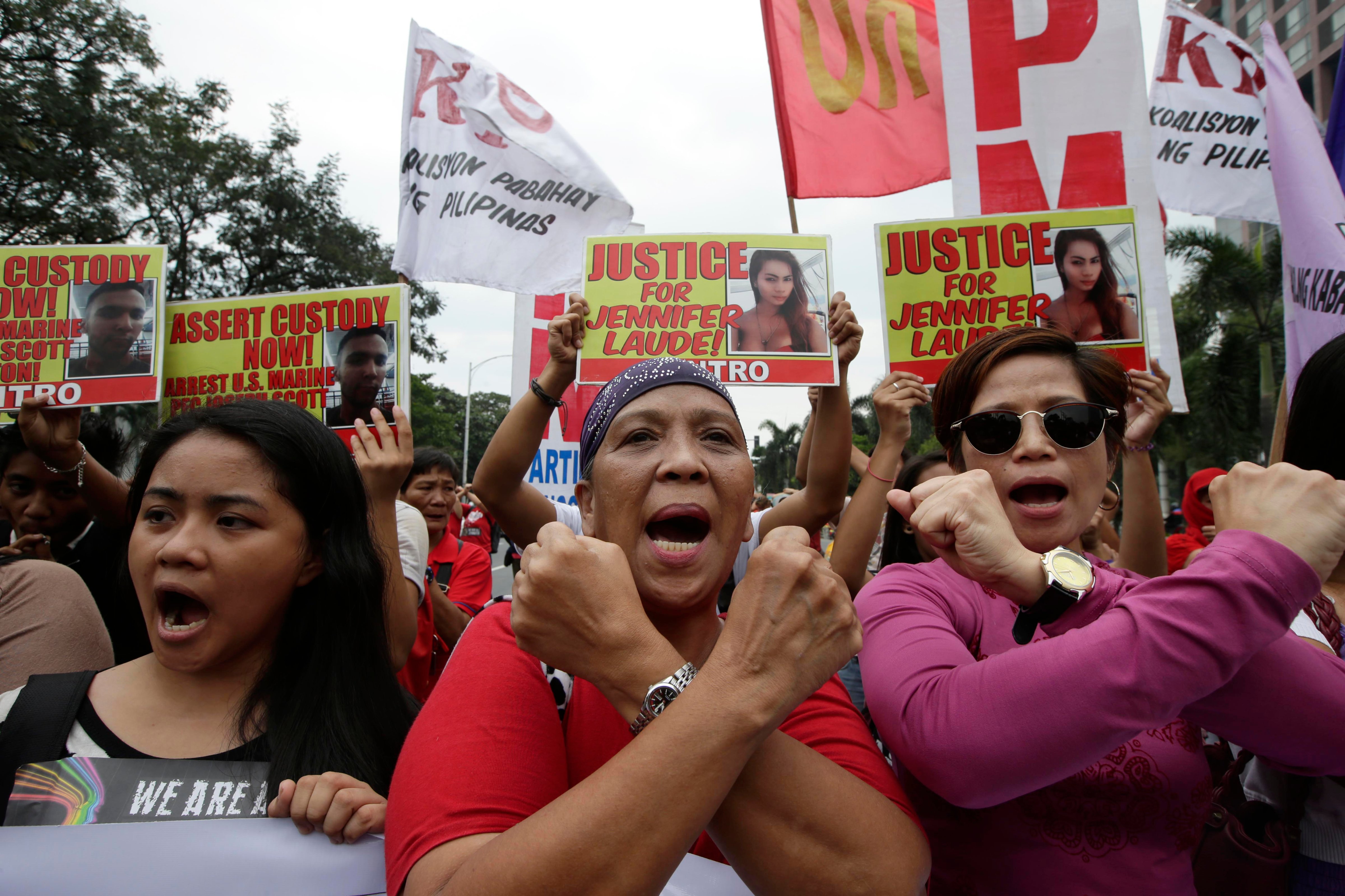 Protesters make cross signs as they shout slogans during a rally outside the U.S. Embassy in Manila, Philippines, Nov. 24, 2014 to demand justice for the Oct. 11 killing of Filipino transgender Jennifer Laude at the former US naval base of Subic. (Bullit Marquez—AP)