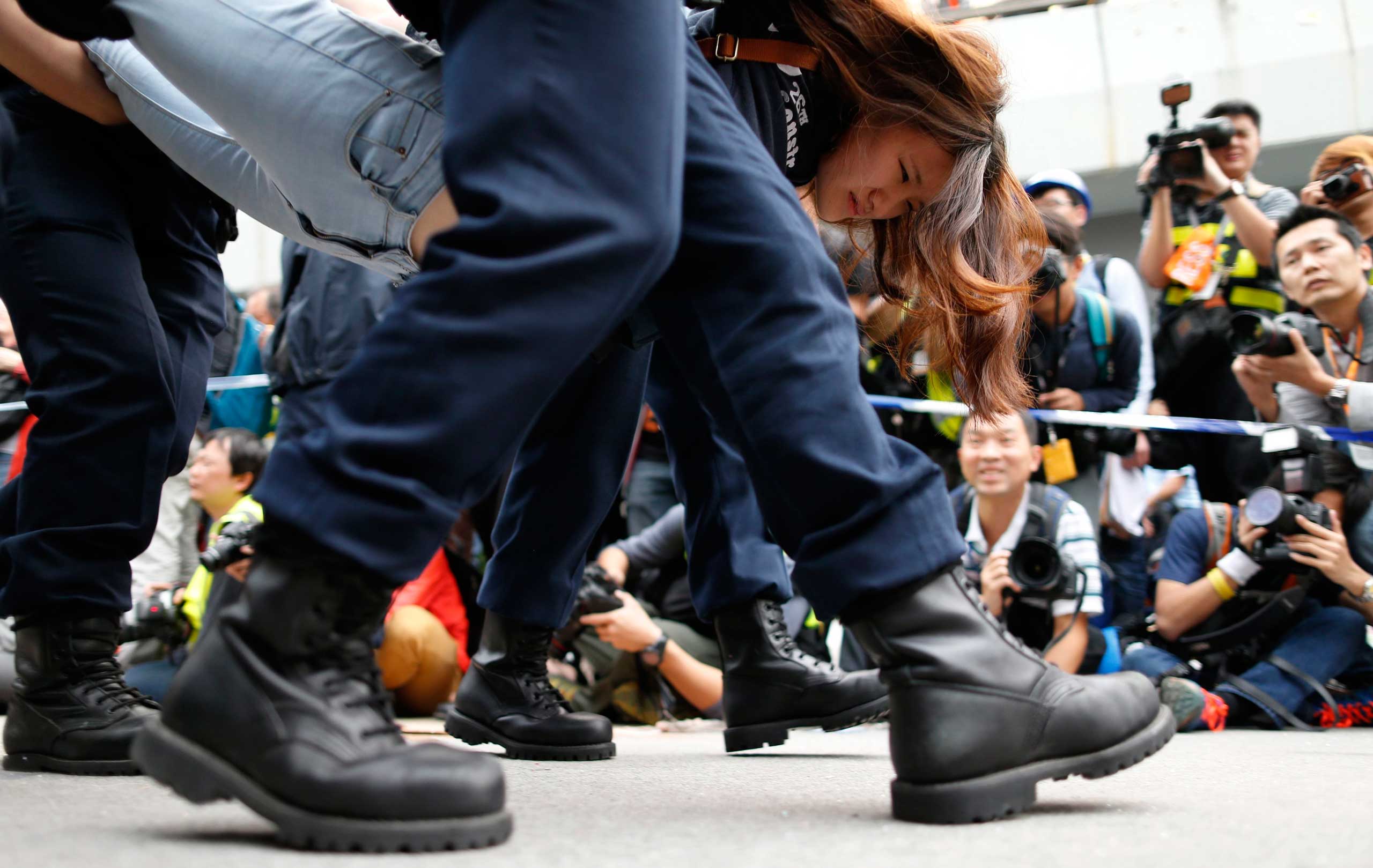 Dec. 11, 2014. A demonstrator is taken away by police from an area previously blocked by pro-democracy supporters, outside the government headquarters in Hong Kong.