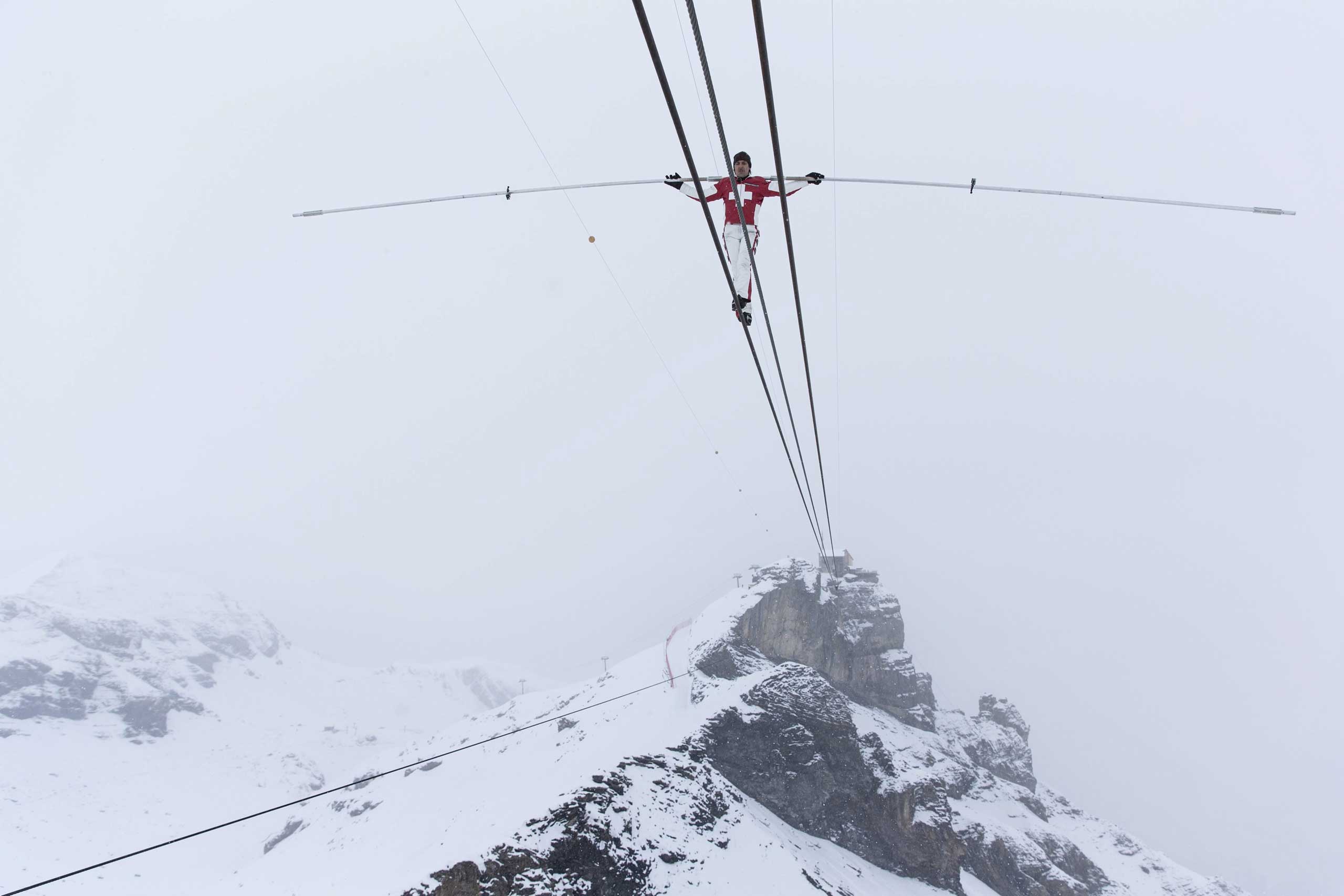 Dec. 10, 2014. Swiss tightrope artist Freddy Nock walks on a rope towards the Schilthorn in the Bernaise alps, Switzerland.
