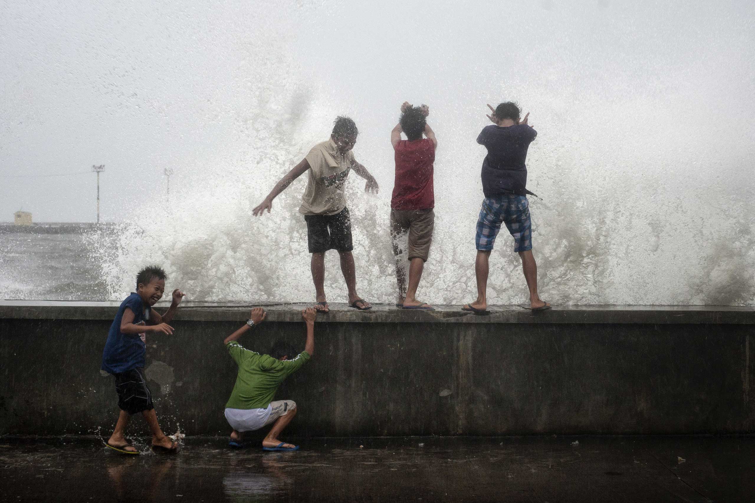 Dec. 7, 2014. Children play at a wharf in Legazpi, Philippines. As Typhoon Hagupit churned across the Philippines, residents of the eastern part of the island nation expressed relief that they had joined the hundreds of thousands who evacuated to safer ground.