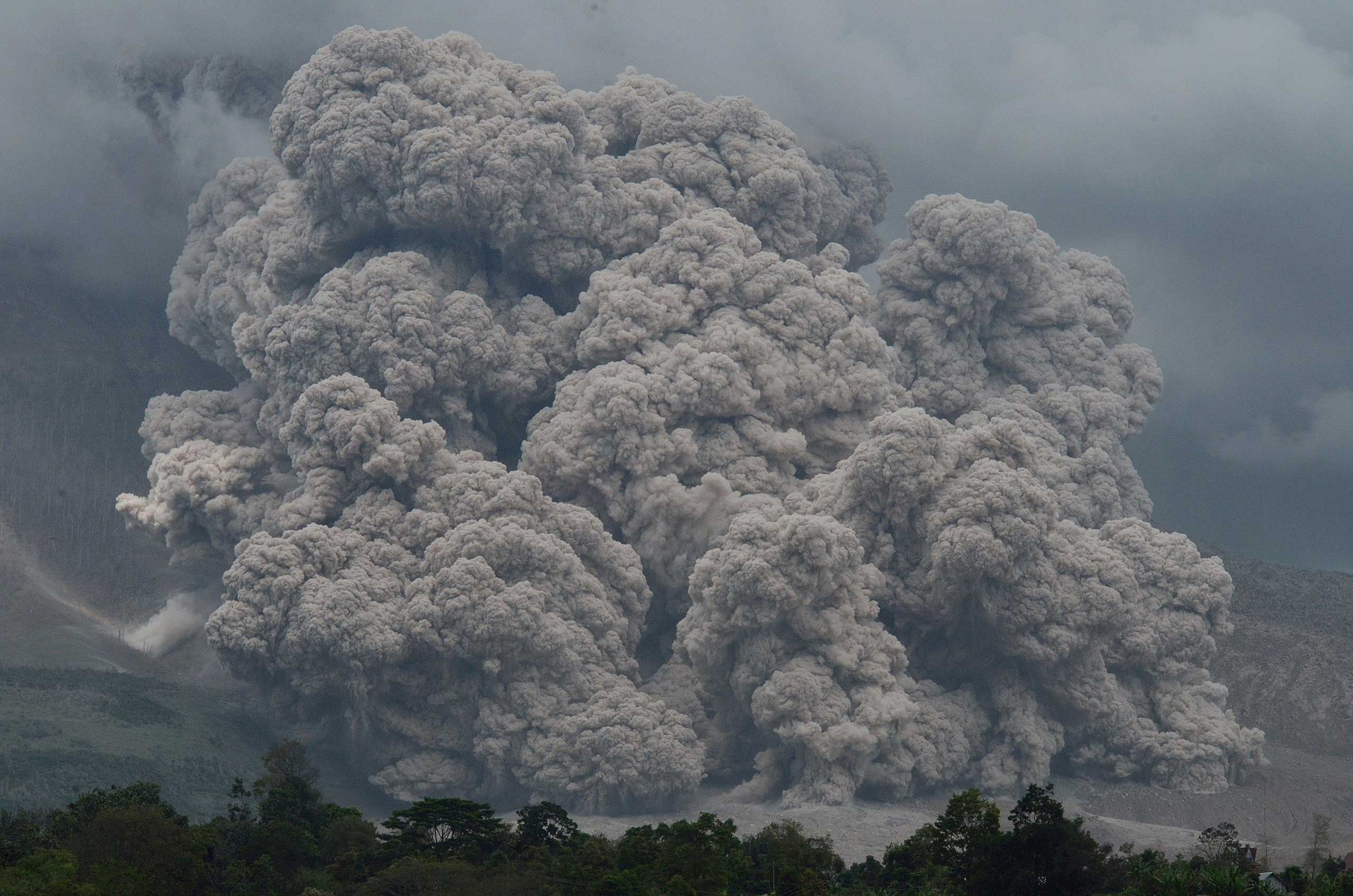 Dec. 9, 2014. Thick and hot smoke spews from Mount Sinabung in Karo, Indonesia. The volcano has been active since September 2013. The local government relocated residents who lived in danger zones  following deadly eruptions in early February that killed about 17 people.