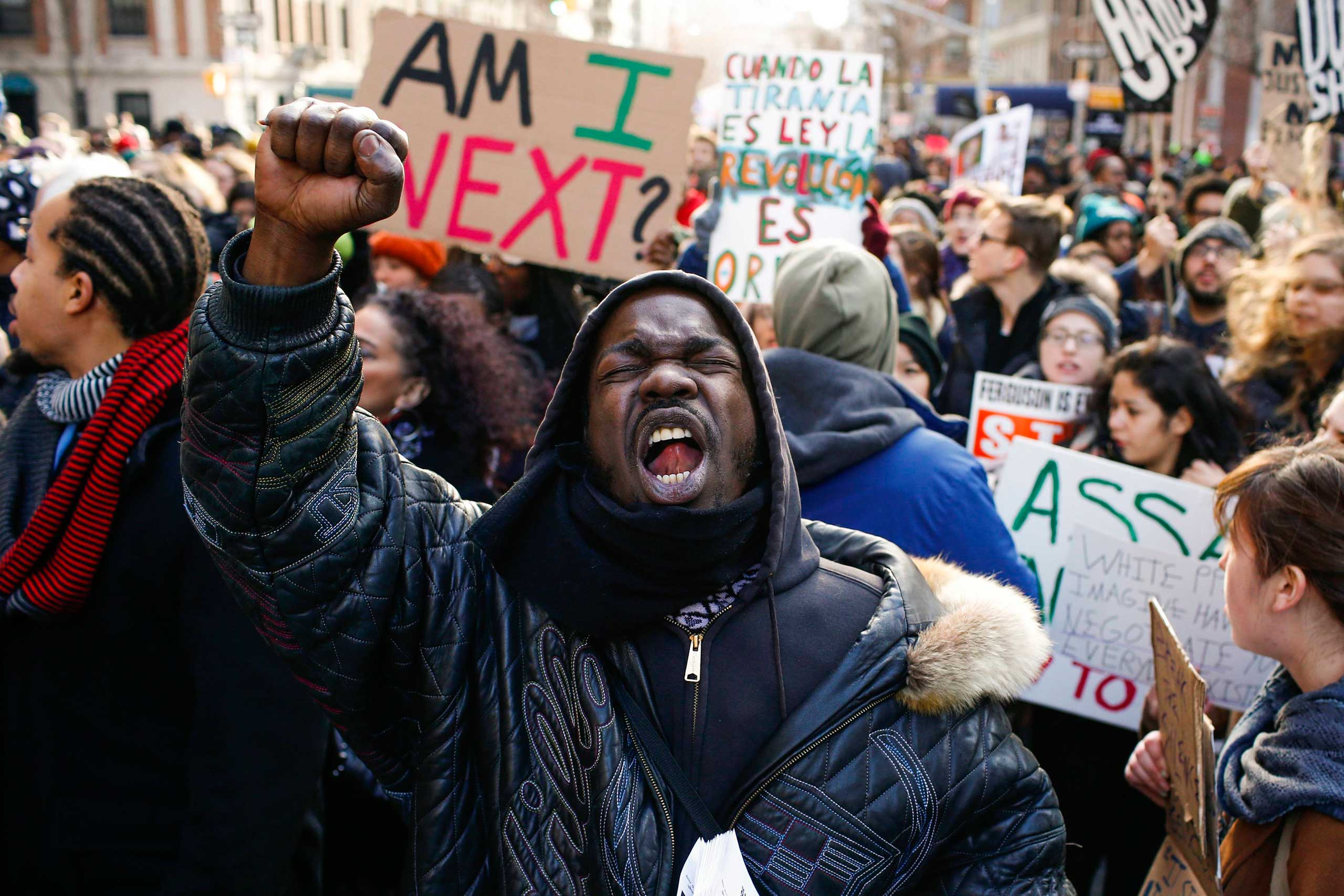 People shout slogans against police as they take part in a march against police violence in New York City on Dec. 13, 2014.