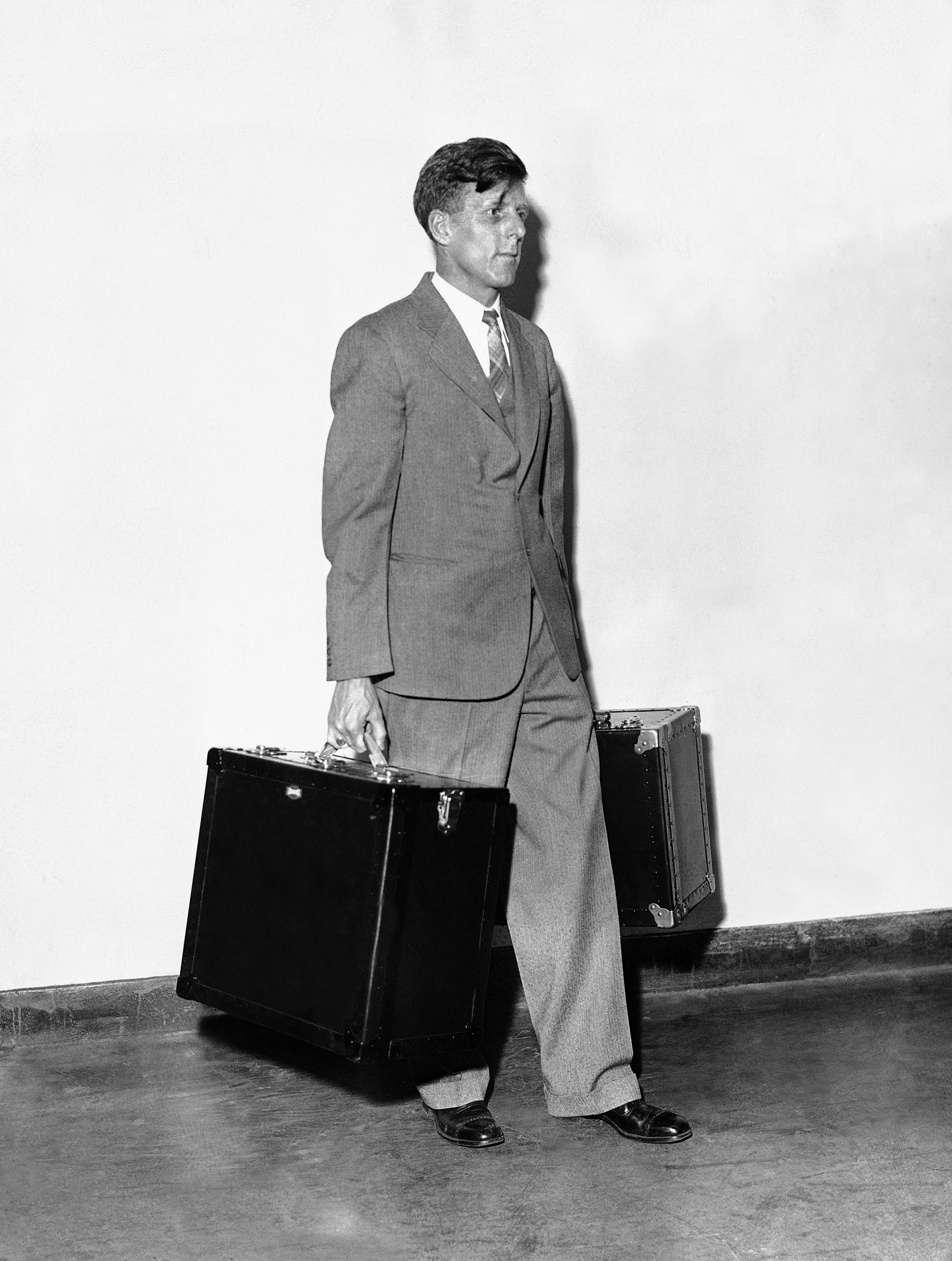 A man carries AP portable WirePhoto transmitter.
