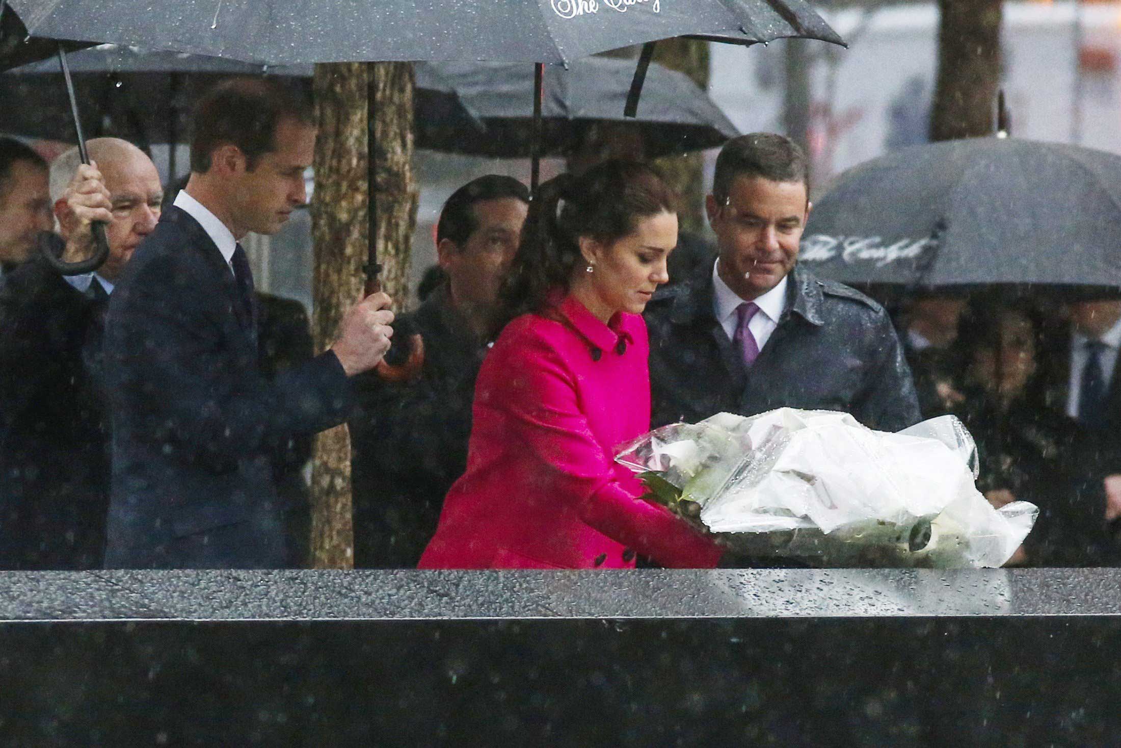 The Duchess Of Cambridge (C) lays a wreath for 9/11 victims next to the Duke of Cambridge while the royal couple pause for reflection in the Memorial Plaza at ground zero in New York City on December 9, 2014. (Eduardo Munoz Alvarez—AFP/Getty Images)