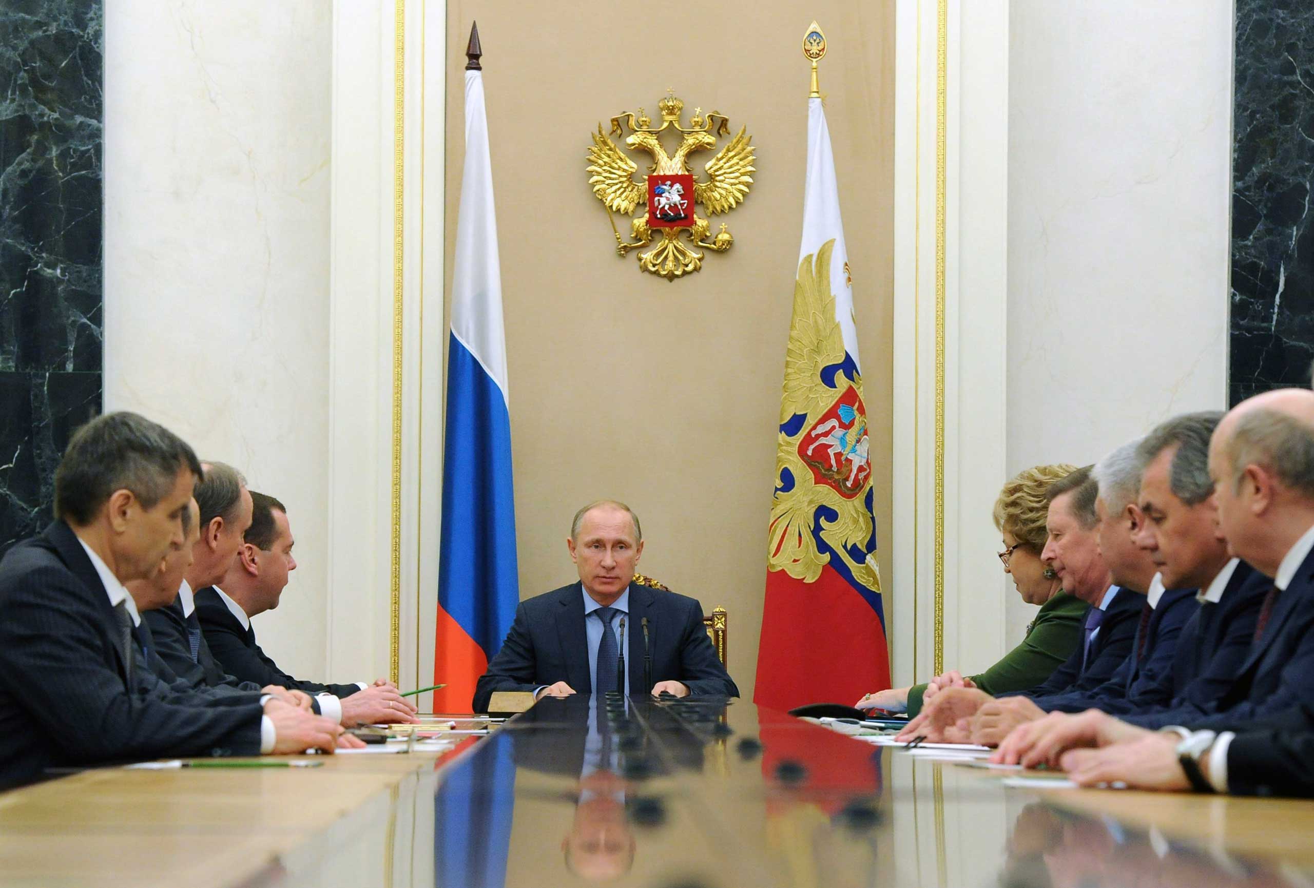 Russia's President Vladimir Putin (C) chairs a meeting with permanent members of the Security Council at the Kremlin in Moscow, December 12, 2014. (Michael Klimentyev—Ria Novosti/Reuters)