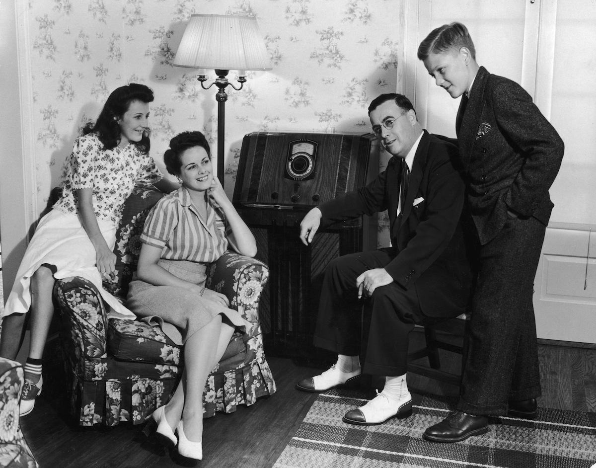Circa 1945,  a family of four gathers in their living room to listen to their home radio set (Harold M. Lambert—Getty Images)