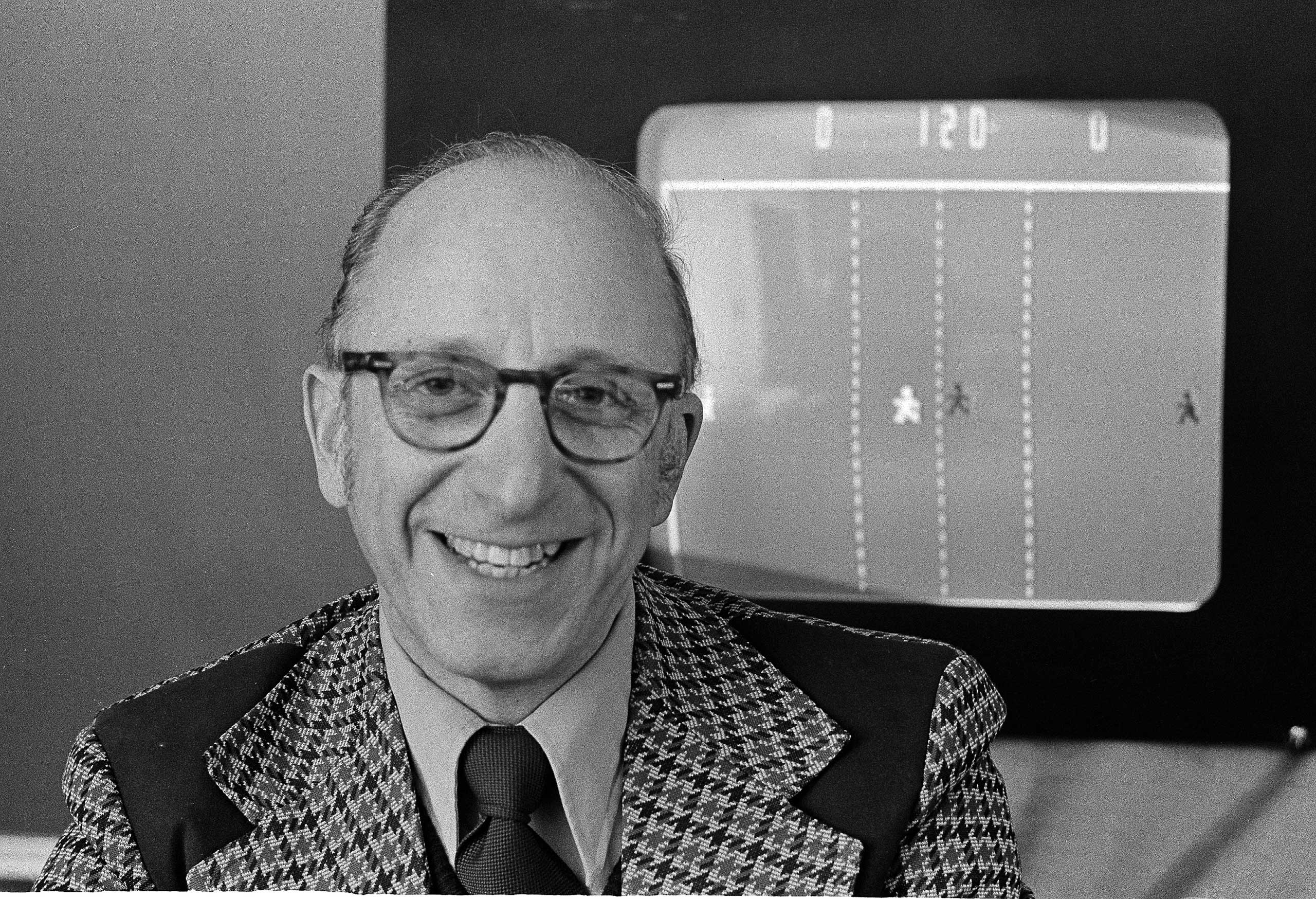 Ralph Baer an engineer for Sanders Associates, Inc., of Nashua, N.H. watches his TV hockey game on Feb. 3, 1977. (CM/AP)