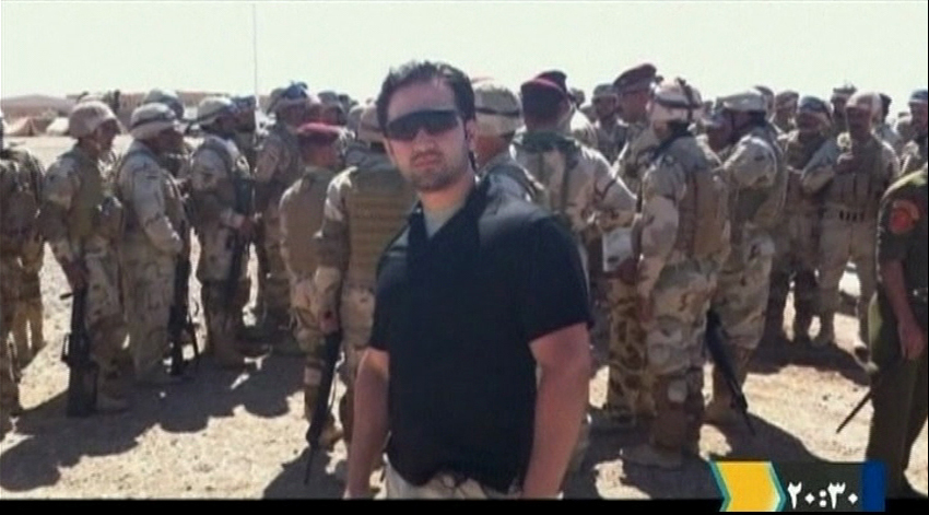 Iranian-American Amir Mirza Hekmati, who has been sentenced to death by Iran's Revolutionary Court on the charge of spying for the CIA,  stands with Iraqi soldiers in this undated still image taken from video in an undisclosed location