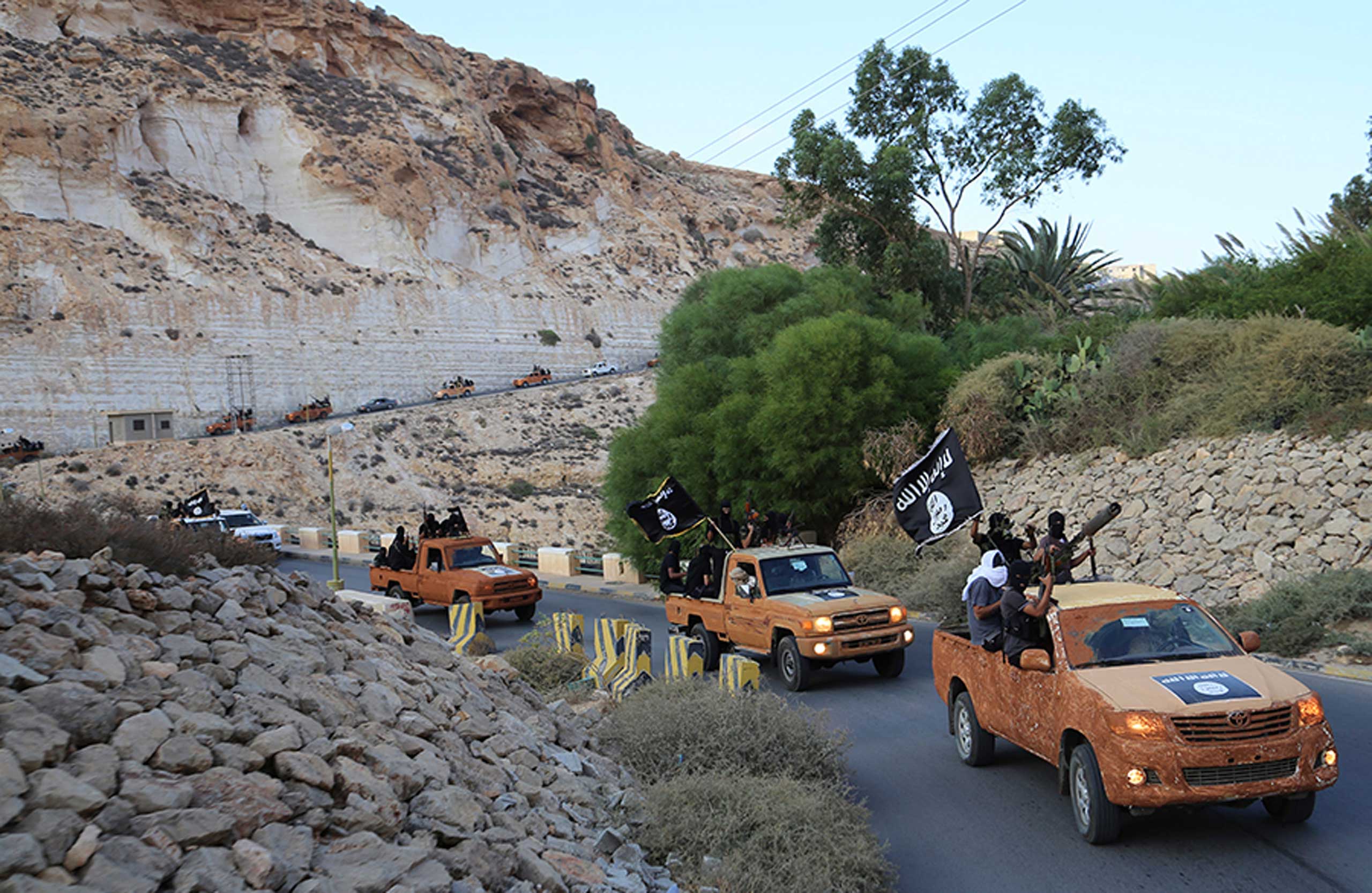 An armed motorcade belonging to members of Darna's Islamic Youth Council, which pledged allegiance to the Islamic State, drive along a road in Derna, eastern Libya, Oct. 3, 2014. (Reuters)