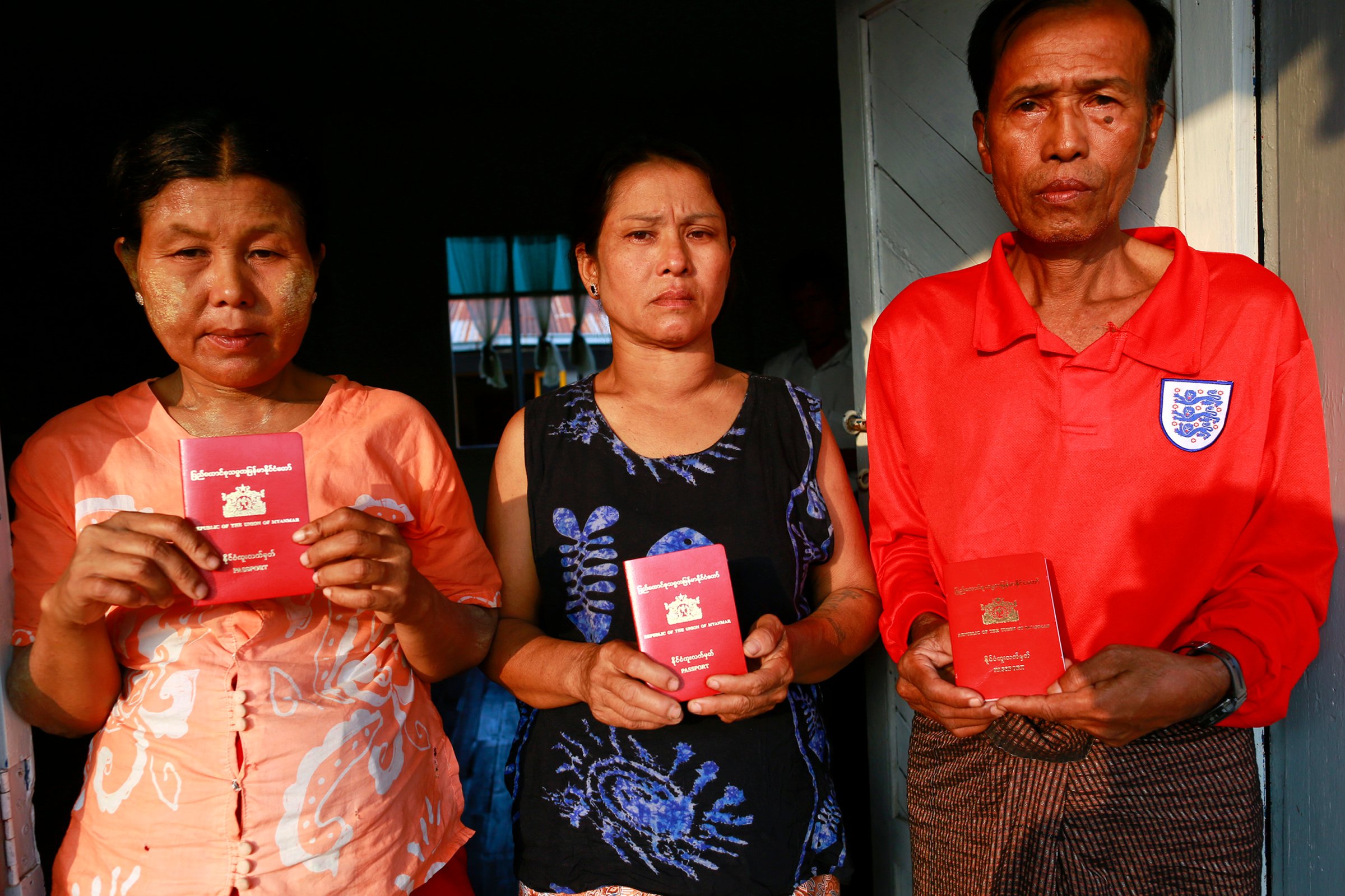 Parents of Myanmar workers suspected of killing British tourist in Thailand, show their passports as at a monastery outside Yangon