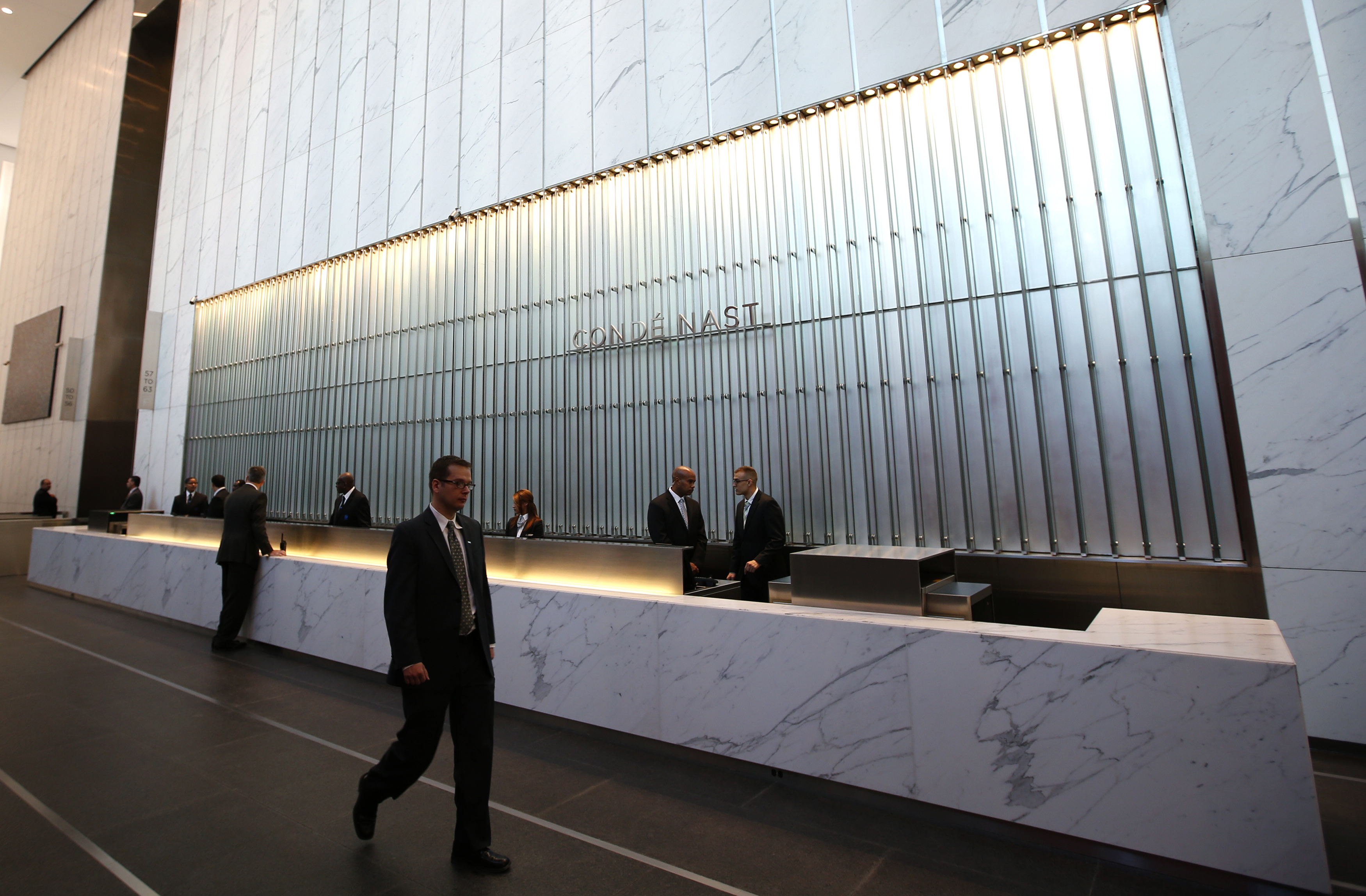 Conde Nast employees work in the lobby of the One World Trade Center tower in New York