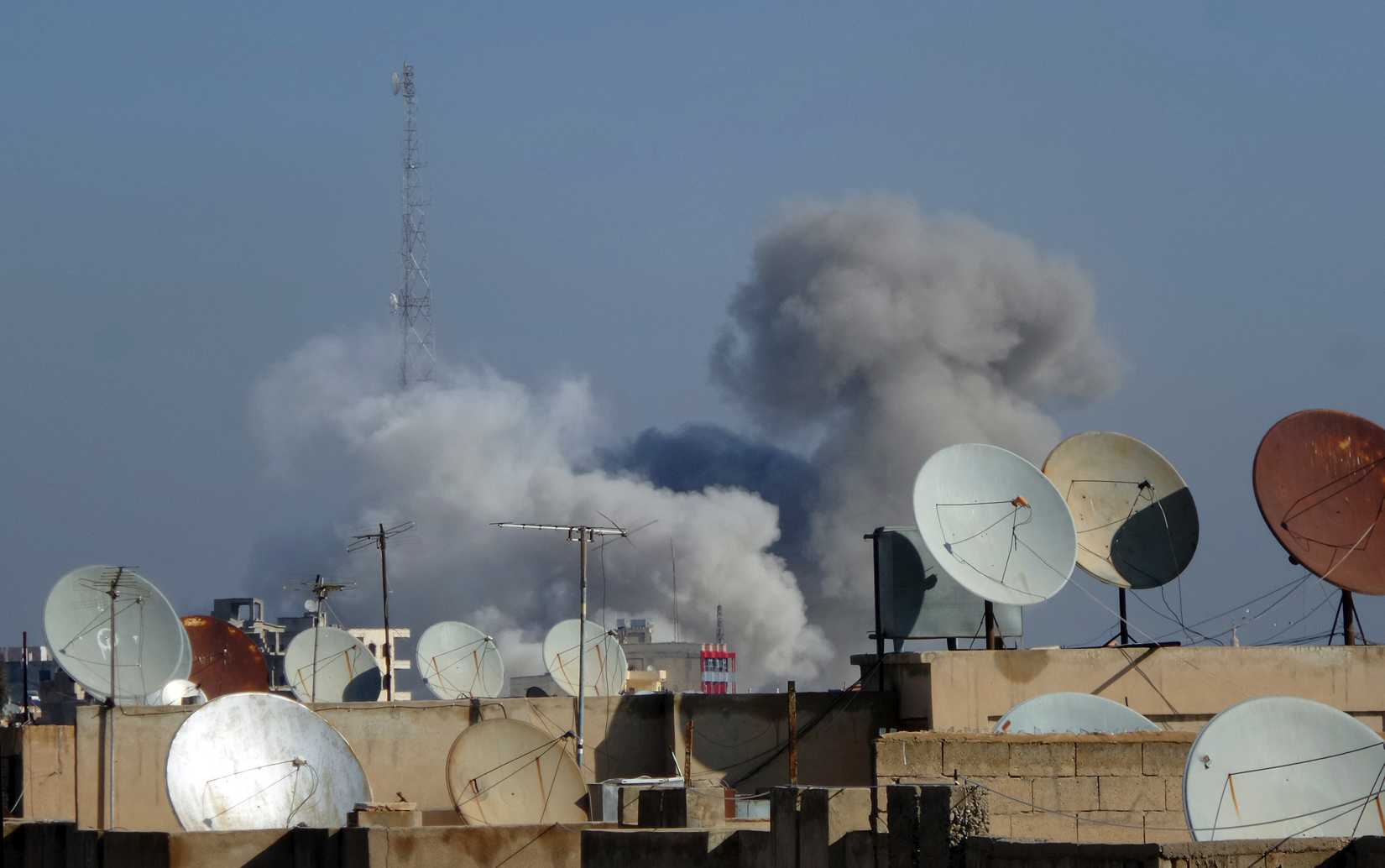 Smoke rises after what activists said were four air strikes by forces loyal to Syria's president Bashar Al-Assad in Raqqa November 28, 2014. (Nour Fourat—Reuters)