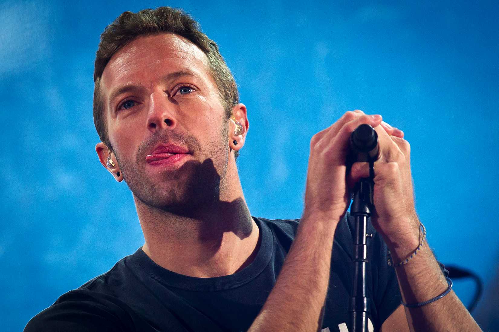 Chris Martin performs with U2 during a surprise concert in support of World AIDS Day in Times Square in New York City on Dec. 1, 2014 (Carlo Allegri—Reuters)