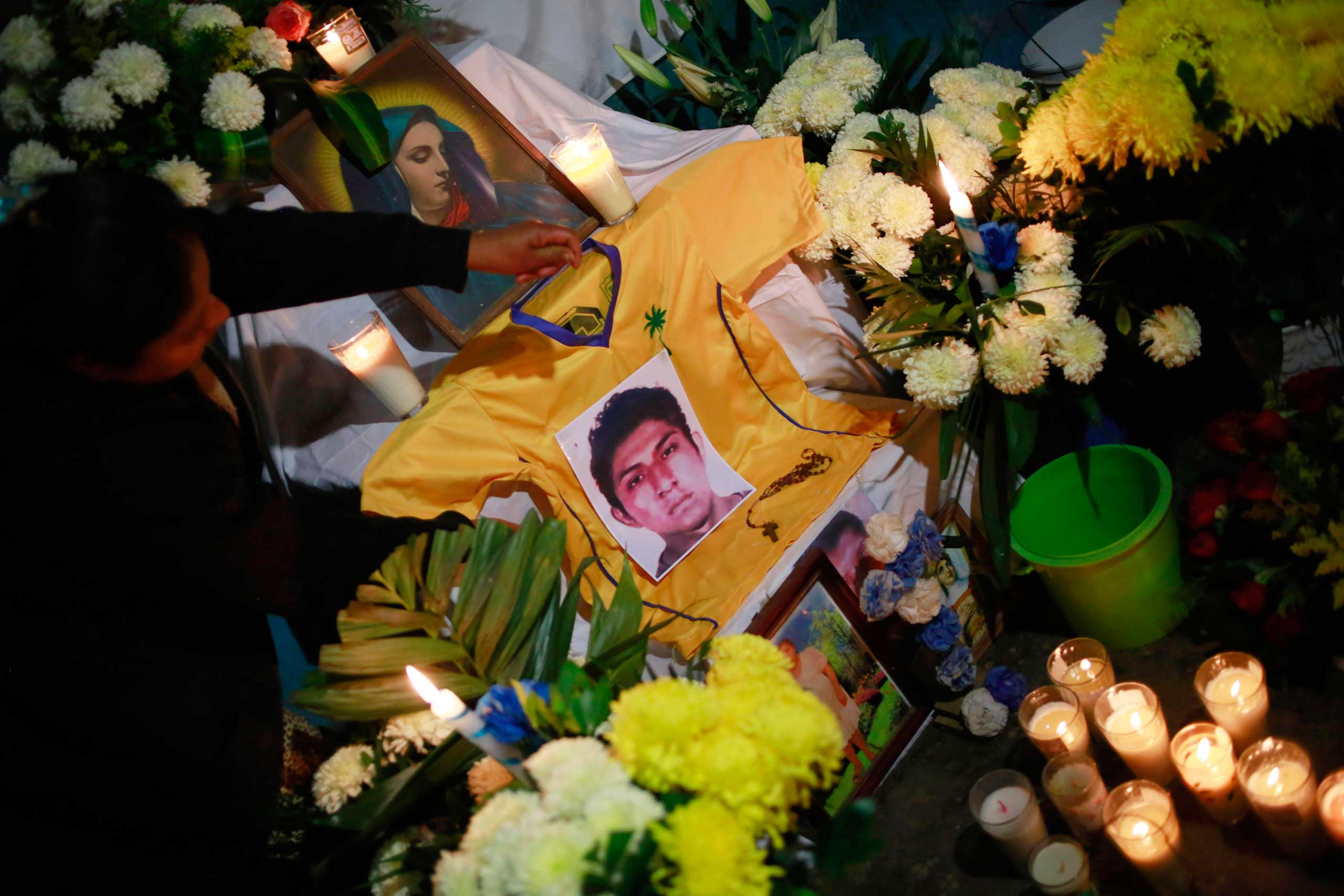 A photo of Alexander Mora Venancio is seen at an altar in the house of his father in El Pericon, in the southern Mexican state of Guerrero