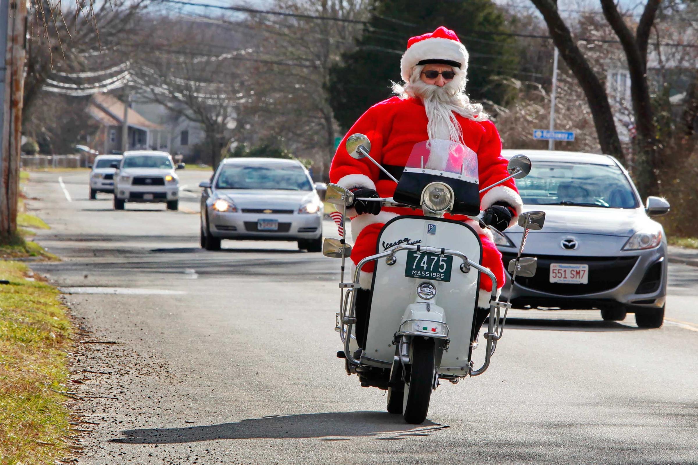 Gene Desrosiers dressed as Santa Claus rides his scooter down on Dec. 19, 2014 in Fairhaven, Mass.