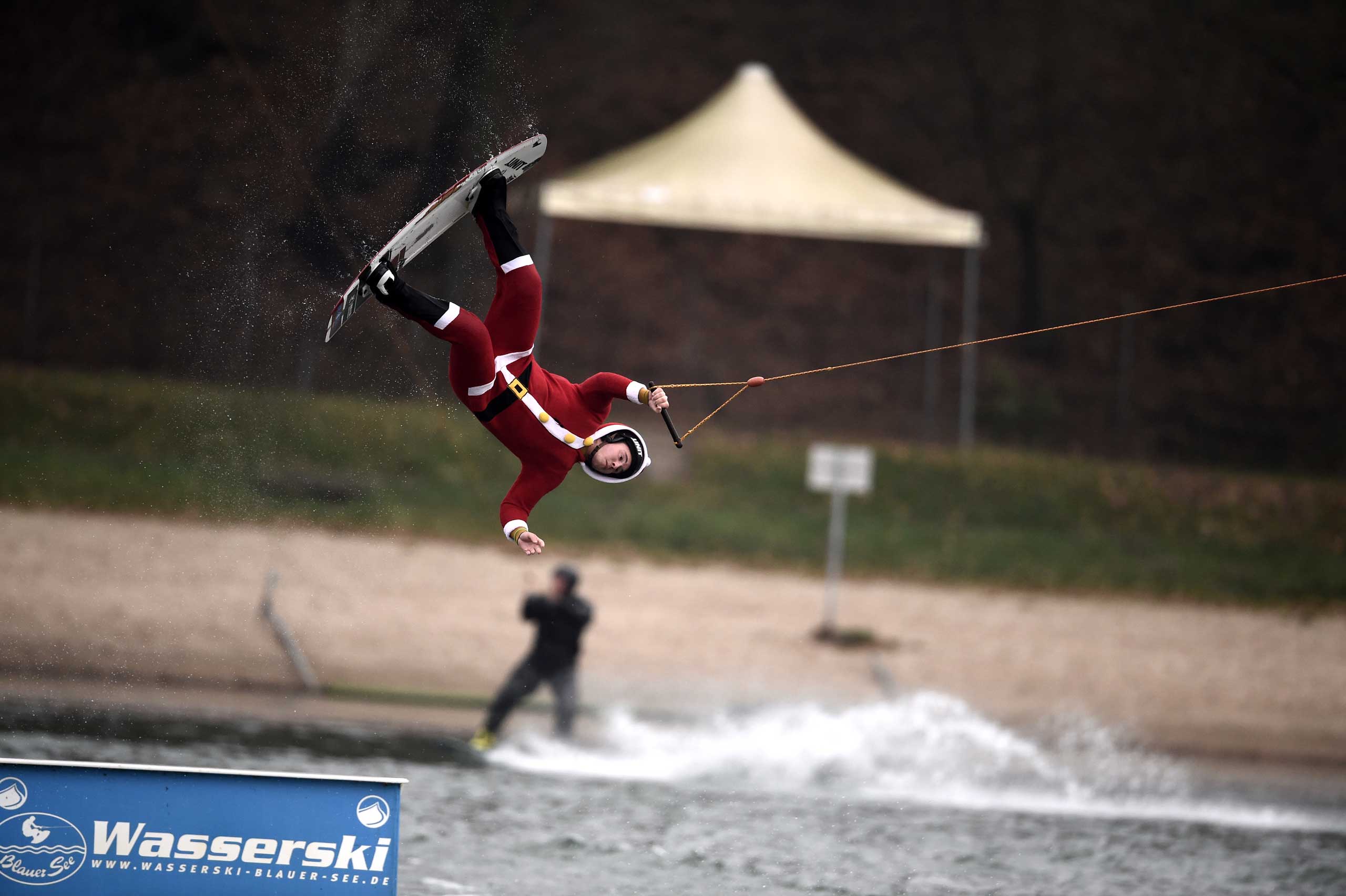 A man dressed as Santa Claus jumps over a barricade on a wakeboard on the Blauer See lake in Garbsen, Germany on Dec. 6, 2014.