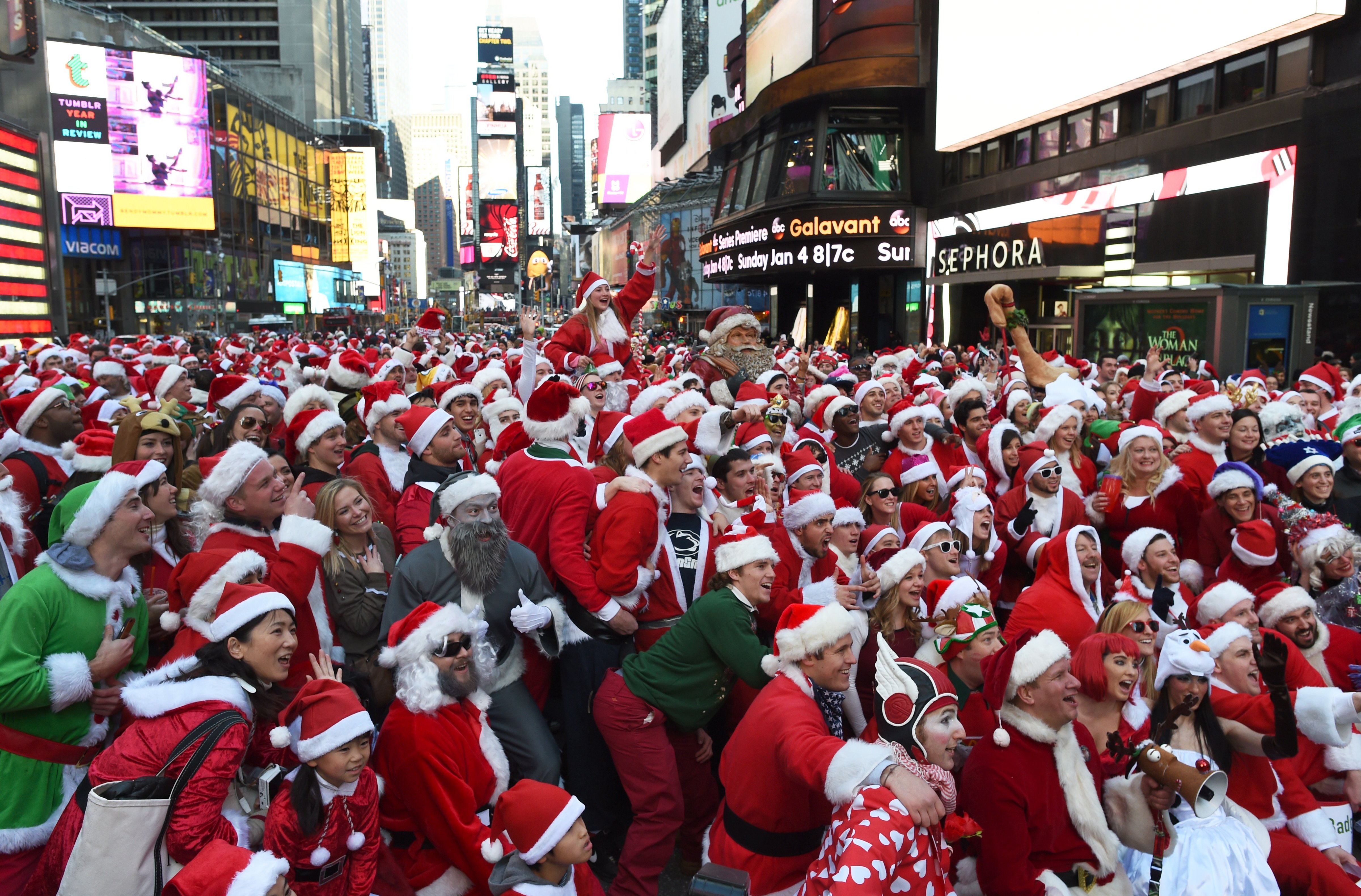 People dressed as Santa Claus and Mrs. Claus celebrate in Times Square as they gather for the annual Santacon festivities on Dec. 13, 2014 in New York. (Don Emmert—AFP/Getty Images)