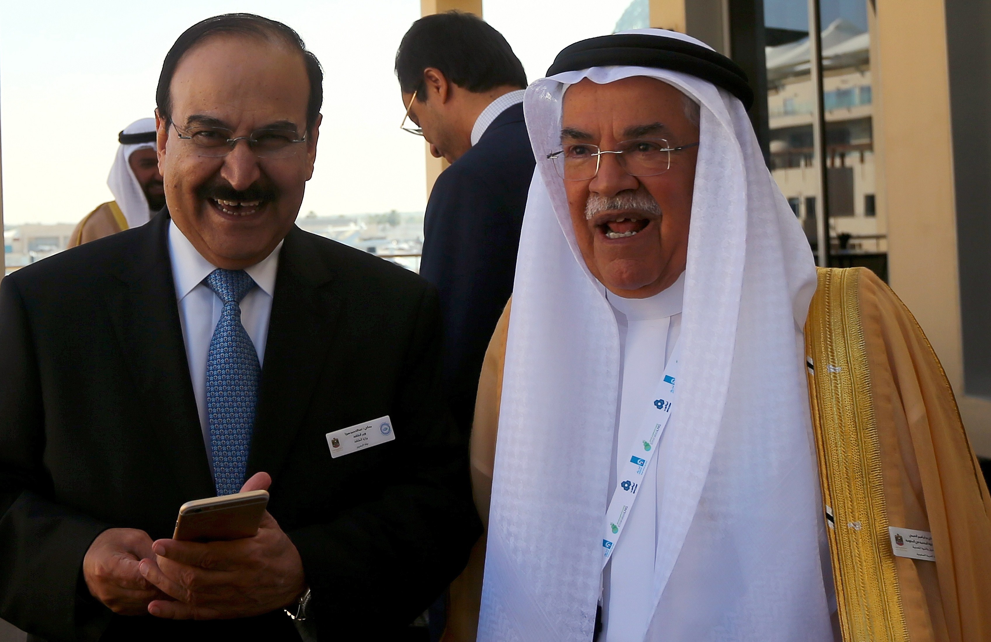 From left: Bahraini Oil Minister Abdulhussain bin Ali Mirza stands with Saudi Oil Minister Ali al-Naimi during the 10th Arab Energy Conference in Abu Dhabi, on Dec. 21, 2014.