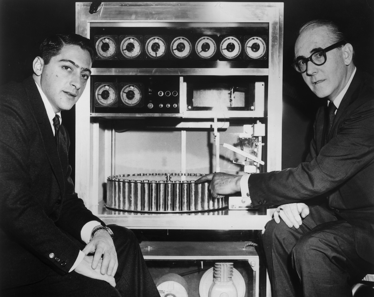 American film producer Mike Todd Jr (left) sits with Swiss inventor Hans Laube, who points to his 'Smell-O-Vision' machine, in 1959 (Hulton Archive / Getty Images)