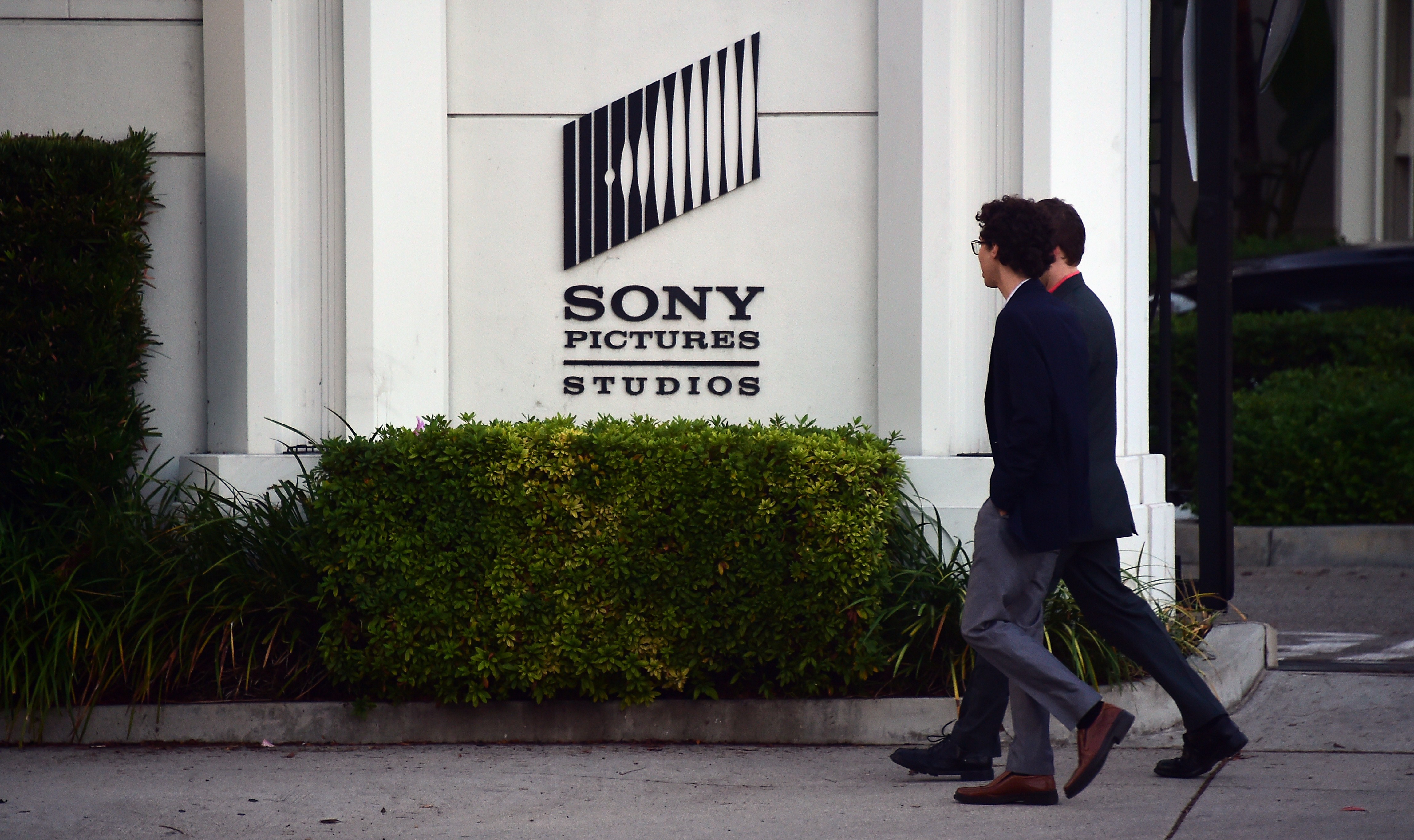 Pedestrians walk past Sony Pictures Studios in Los Angeles on Dec. 4, 2014.