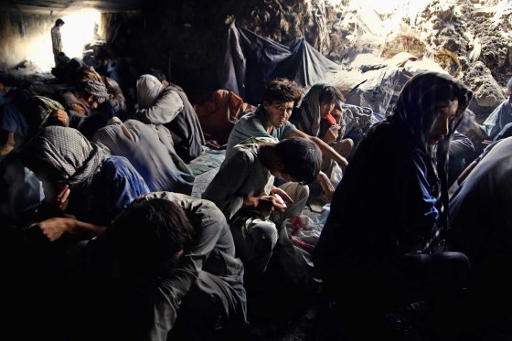 Addicts under the Pul-e Sukhta bridge, sheltering from the burning summer sun above on Aug. 26, 2014.