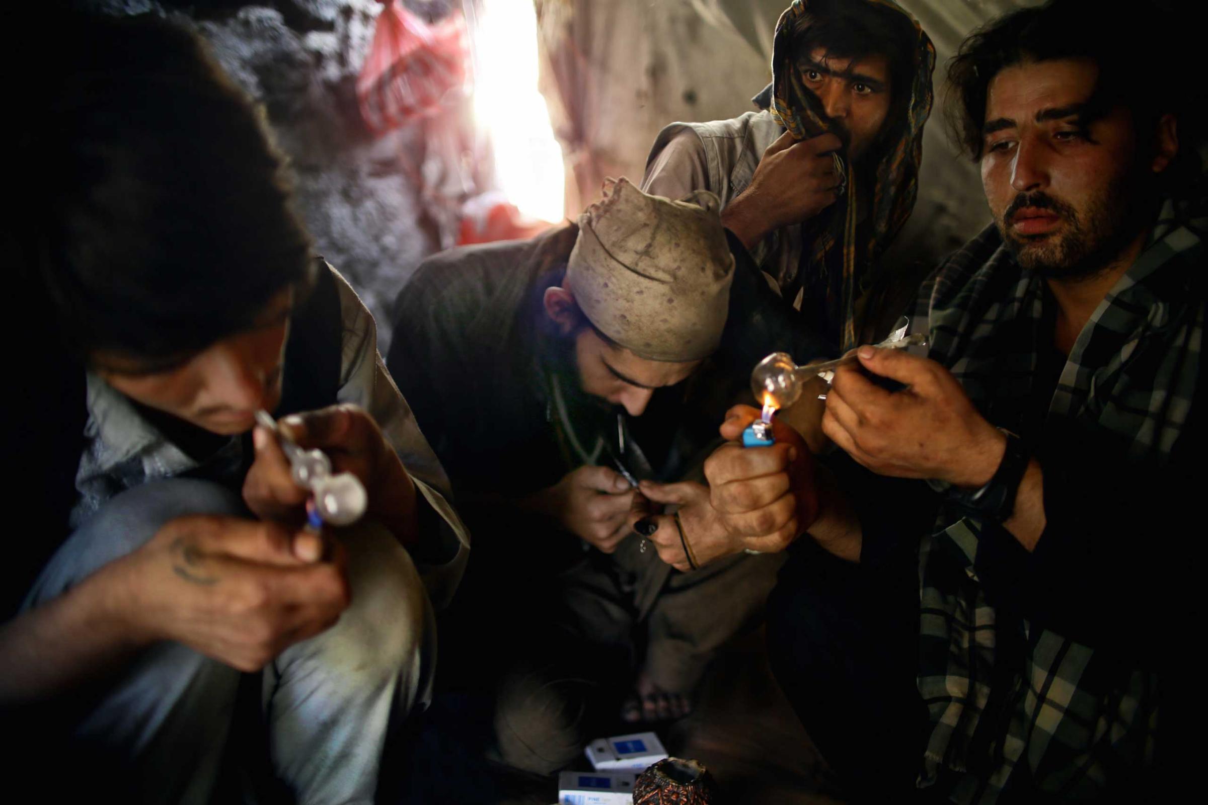 Beneath the Pul-e Sukhta bridge in Western Kabul a group of Pakistani heroin addicts take refuge from the summer sun, huddled within a tent - smoking, injecting and sleeping in a putrid squalor. Pictured above are Emal, Rahim, Ajmal and Wahid (left to right) who have been sharing a tent for the past two weeks.
