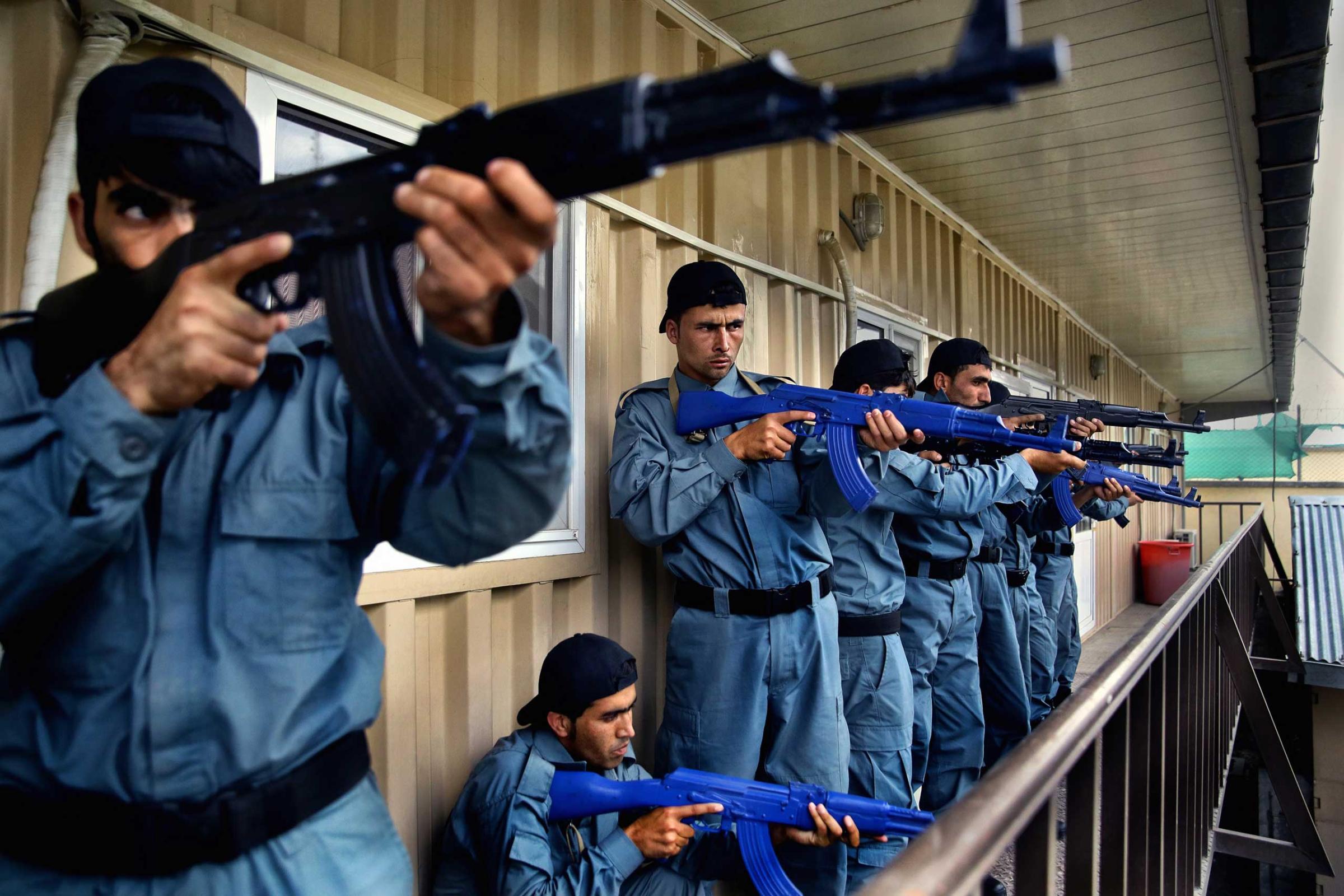 Afghan National Police officers from the Anti-Narcotics Quick Reaction Force (ANQRF) carry out a raid scenario exercise intended for drug traffickers at a training centre in Kabul on Aug. 25, 2014.