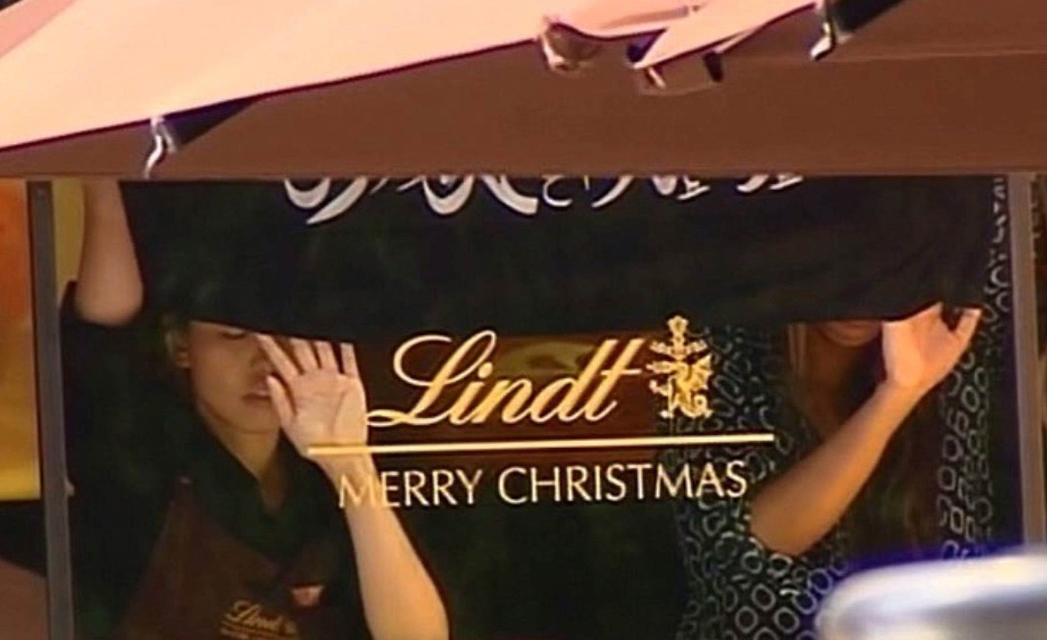 This screengrab taken from the Australian Channel Seven broadcast shows presumed hostages holding up a flag with Arabic writing inside a cafe in the central business district of Sydney on December 15, 2014. (Channel Seven—AFP/Getty Images)