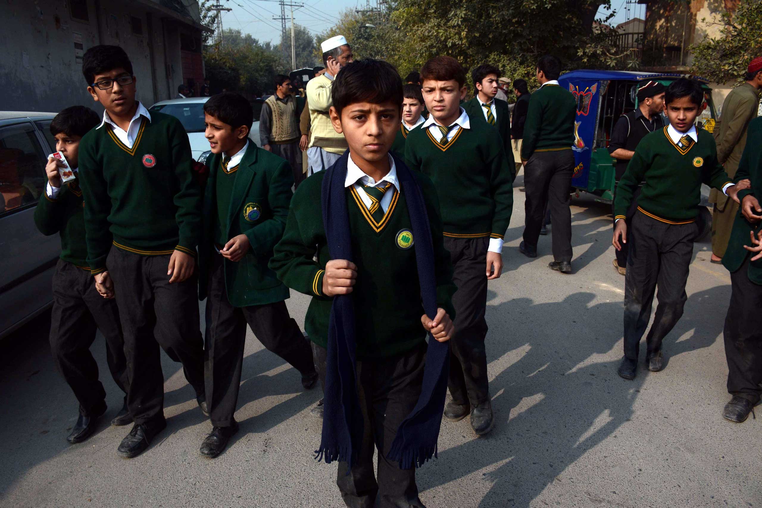 School children rescued by Pakistani security forces leave following an attack at the Army run school, in Peshawar on Dec. 16, 2014. (Bilawal Arbab—EPA)