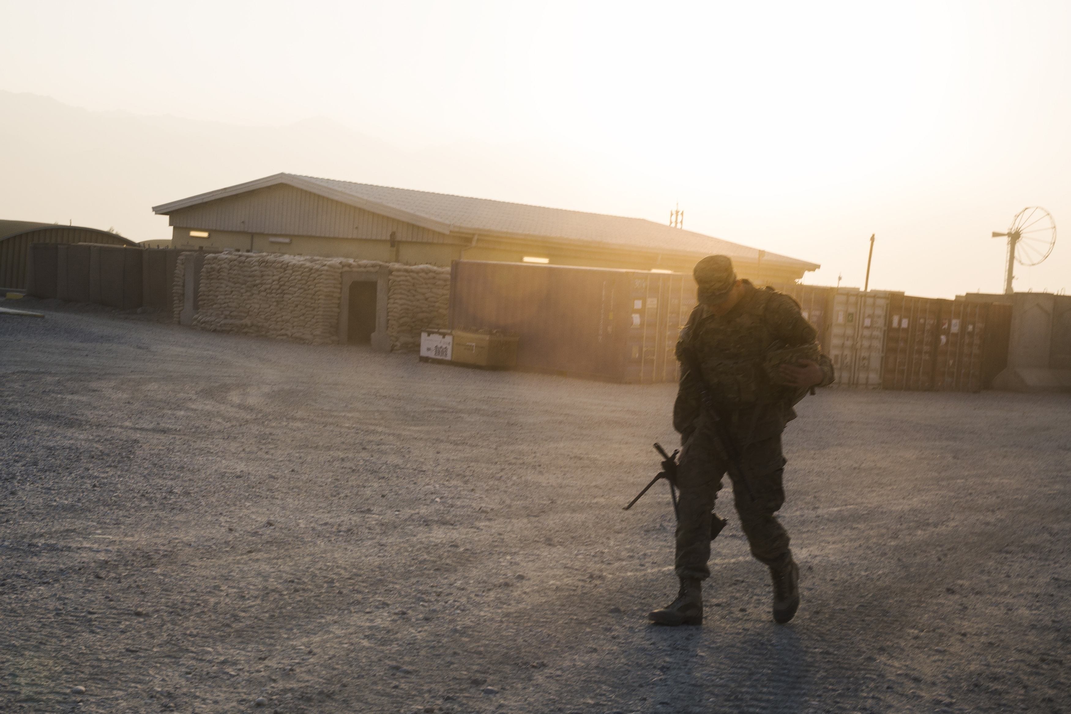 A U.S. soldier from the 3rd Cavalry Regiment walks with his rifle, after returning from a mission at forward operating base Gamberi, in the Laghman province of Afghanistan