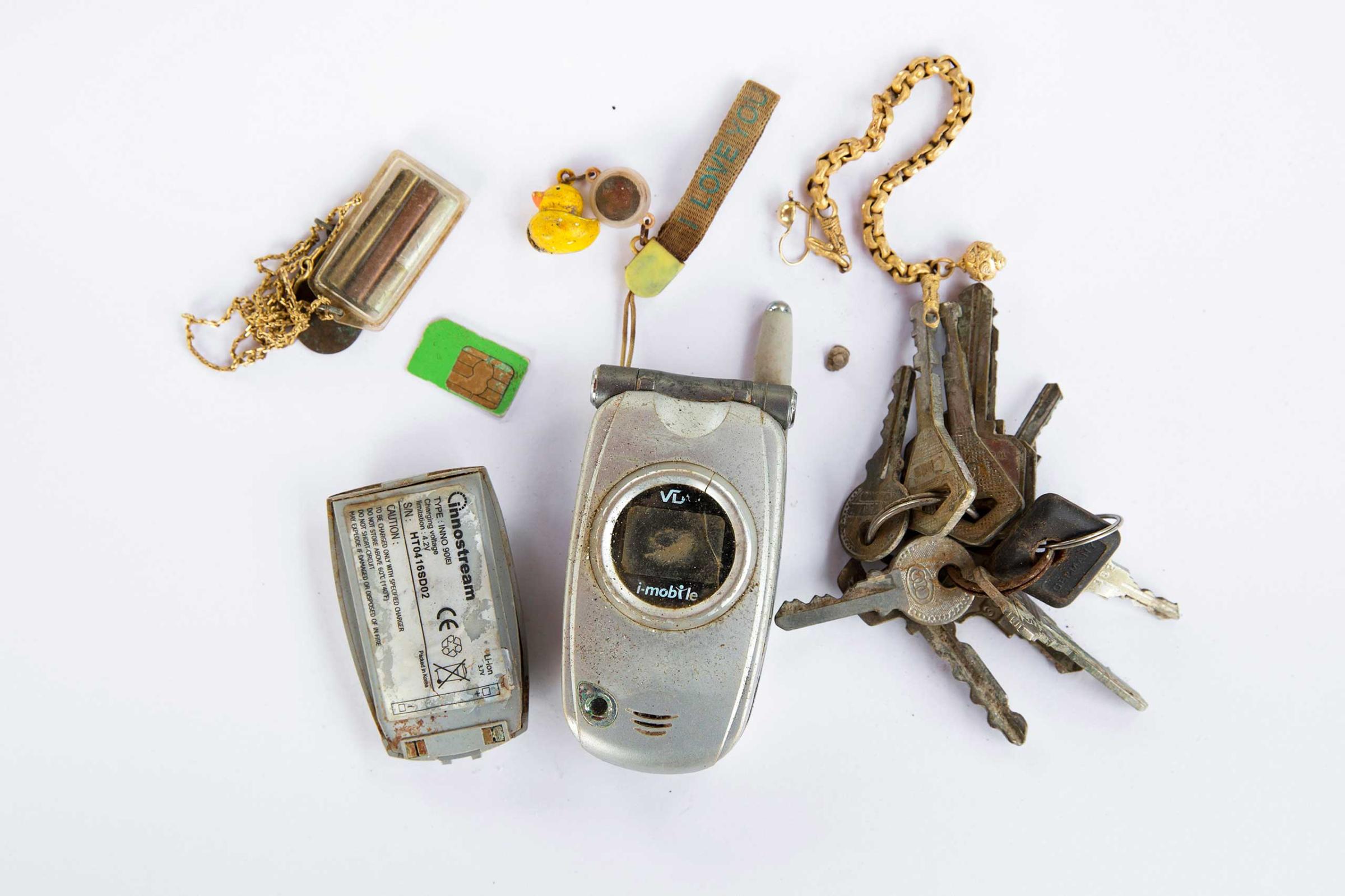 Personal possessions of 2004 tsunami victims are arranged to be photographed outside a police station in Takua Pa