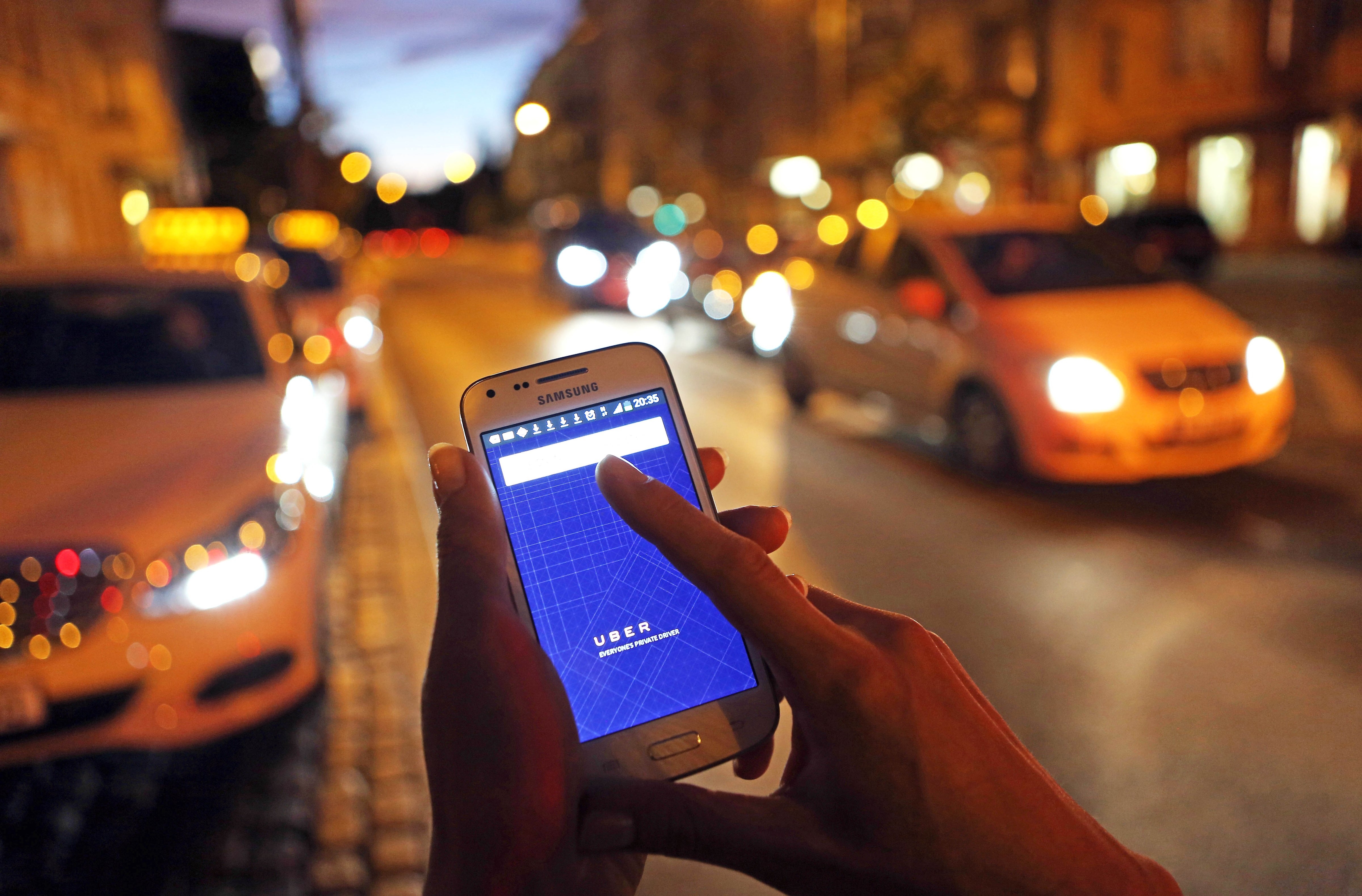 A woman uses the Uber app on an Samsung smartphone on Sept. 2, 2014 in Berlin. (Adam Berry—Getty Images)
