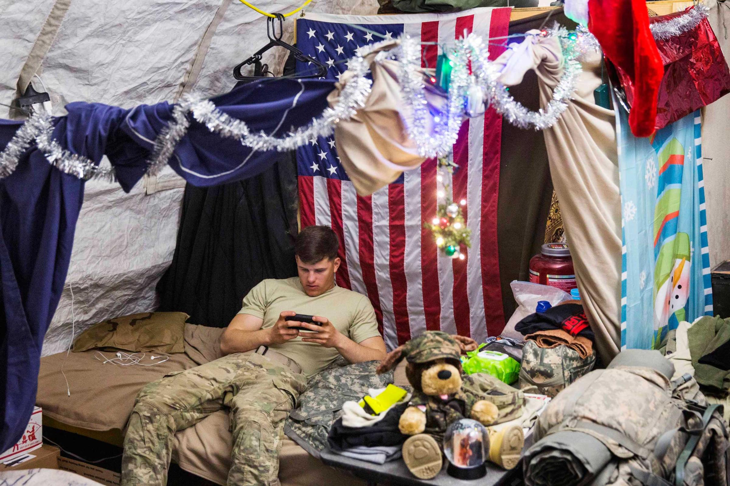 U.S. soldier from the 3rd Cavalry Regiment relaxes in his quarters after taking part in a mortar exercise on forward operating base Gamberi in the Laghman province of Afghanistan