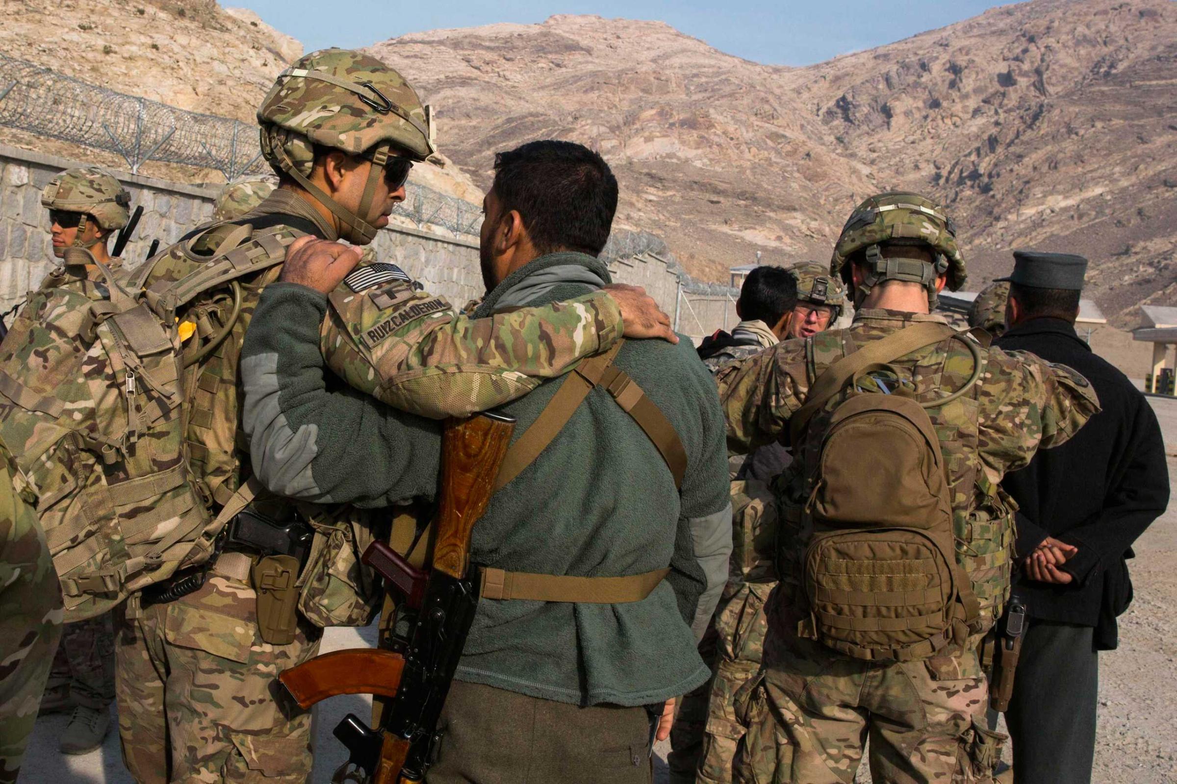 U.S. soldiers from the 3rd Cavalry Regiment greet their Afghan police counterparts during an advising mission to an Afghan police station constructed by ISAF near Jalalabad