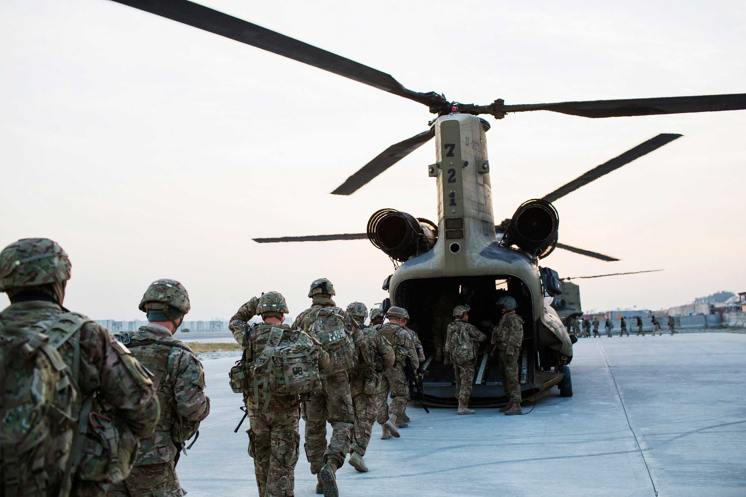 U.S. soldiers from the 3rd Cavalry Regiment load into a CH-47 Chinook helicopter for an advising mission to an Afghan National Army base at forward operating base Fenty in the Nangarhar province of Afghanistan on Dec. 21, 2014.