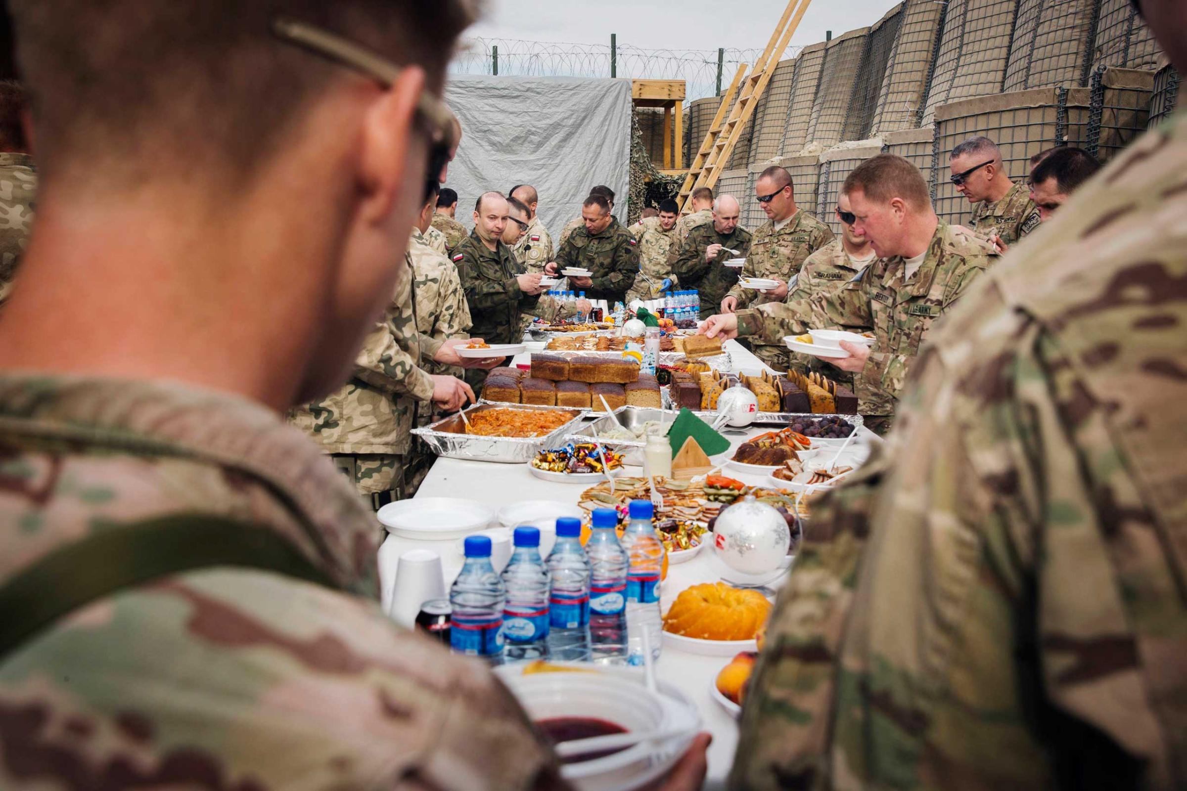 U.S. soldiers from the 3rd Cavalry Regiment take part in a Christmas Eve celebration with soldiers from the Polish army's 21st Mountain Brigade on forward operating base Gamberi in the Laghman province of Afghanistan