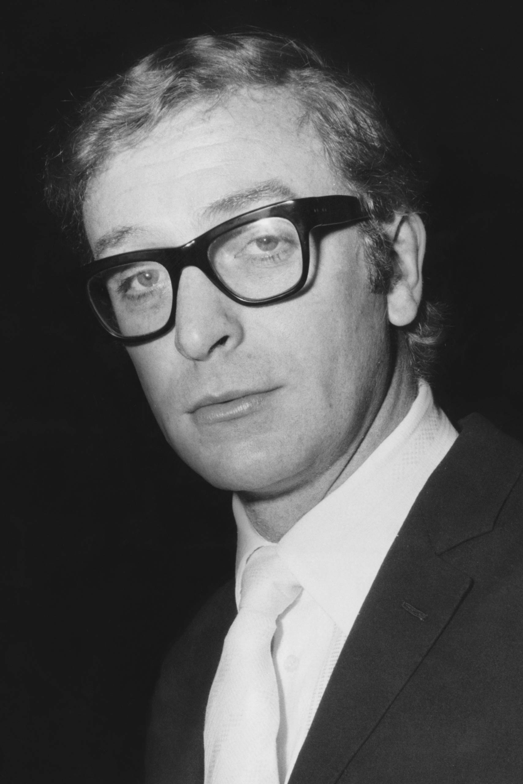Michael Caine It takes decades of acting experience in order to be able to babysit eccentric billionaires with a penchant for wearing black. Born Maurice Joseph Micklewhite, the British actor would adopt the stage name “Michael Scott” and finally “Michael Caine” in the 1950s when he toured the various theaters in England to start off his career.