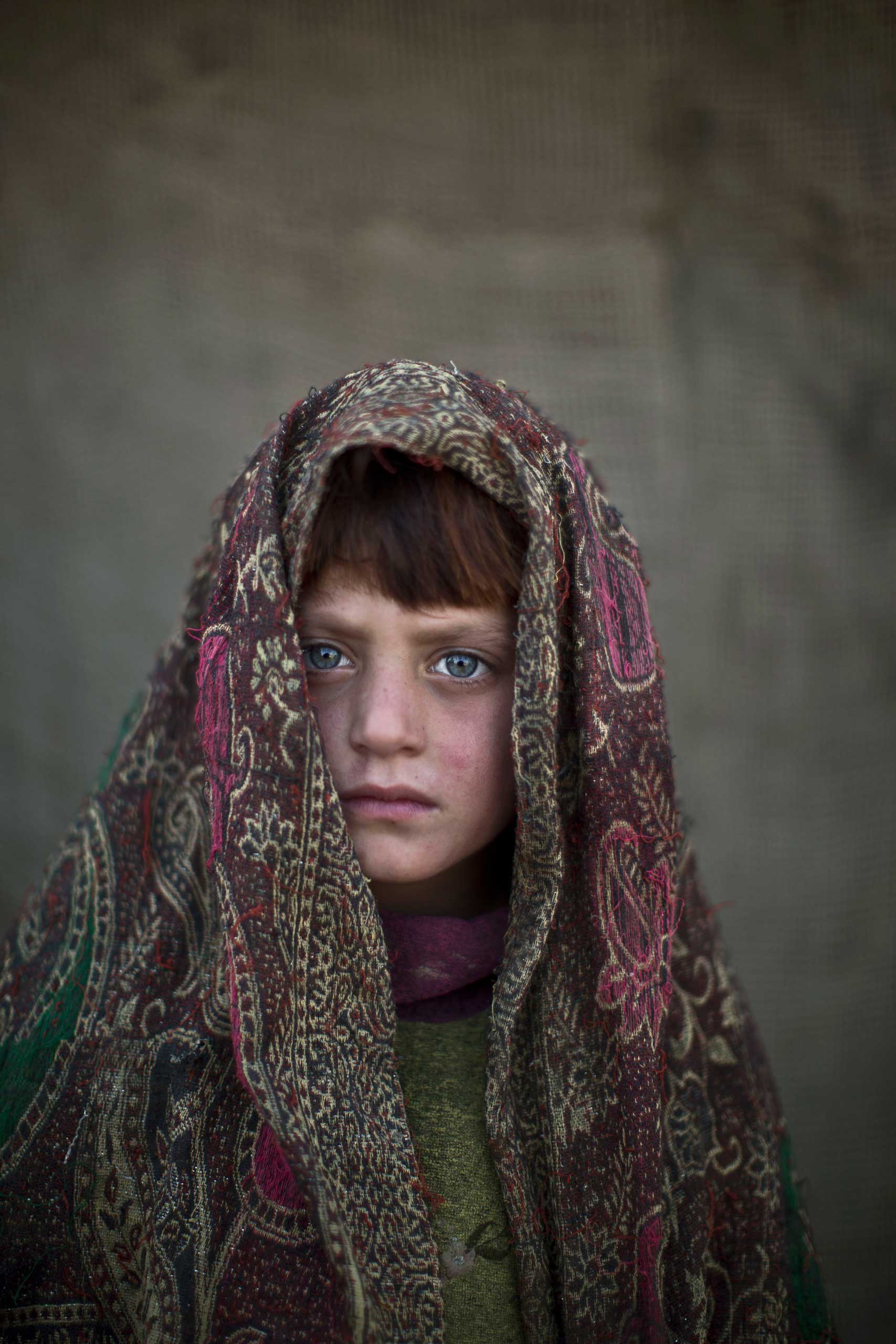 Afghan refugee girl, Naseebah Zarghoul, 6, poses for a picture, while playing with other children in a slum on the outskirts of Islamabad, Pakistan. Jan. 24, 2014.