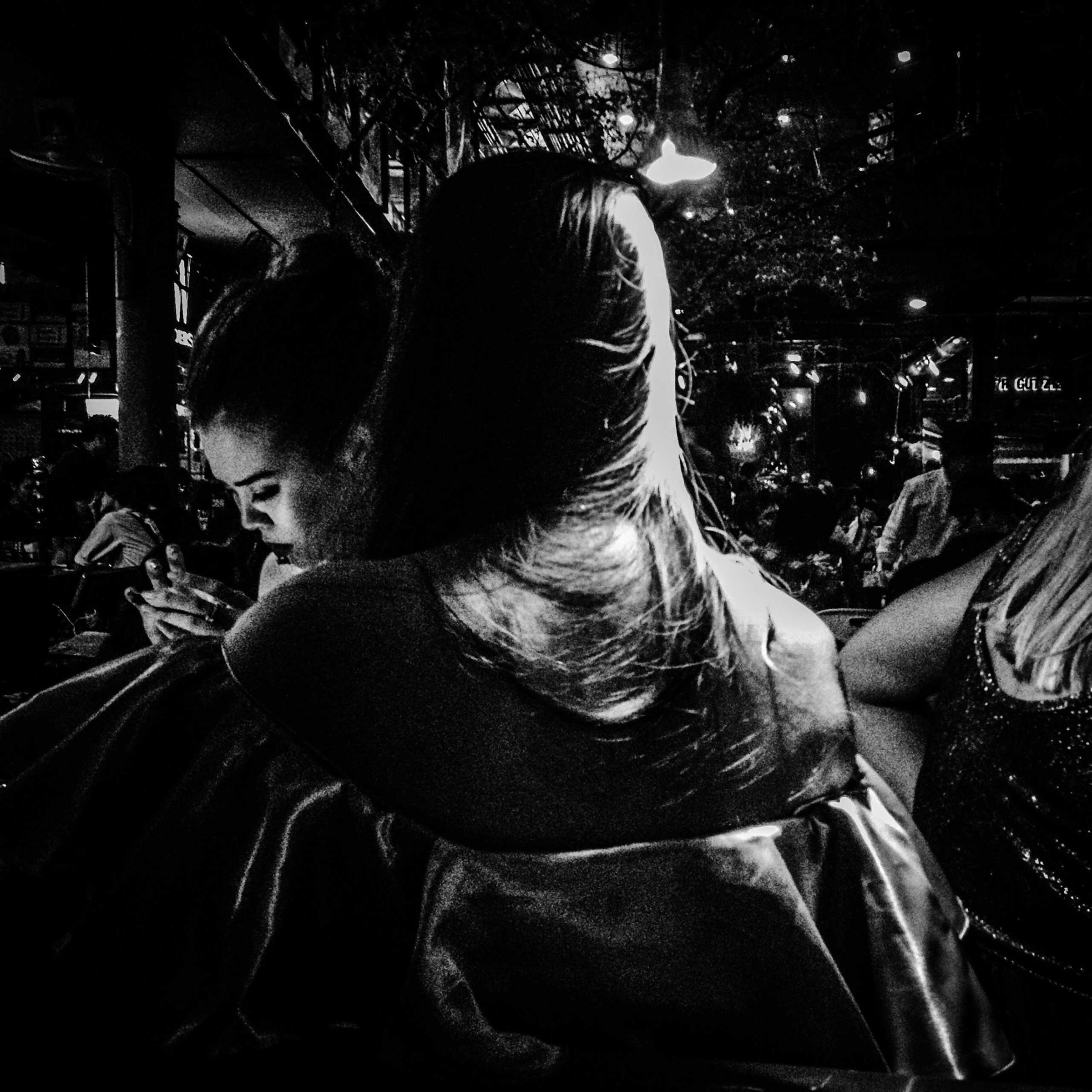 In this image, taken on Thonglor Soi (alley) 13, several girls are spending their evening at Scenespace, a collection of bars and restaurants with outdoor seating that is popular almost every night of the week. Thonglor is one of Bangkok's most hip streets, catering mostly to wealthy 20 and 30 somethings. You won't find drunk backpackers here and it remains relatively free of the prostitution and sex clubs - at least openly - that Bangkok has long been famous for but that really only represent small sections of an otherwise interesting and fascinating city.Photo by @amcaptures (andre malerba)