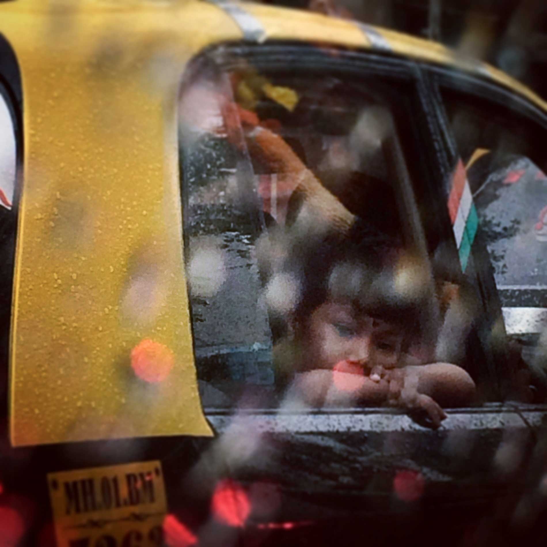 A girl looks out of a taxi window in Mumbai, India in August of 2014 during one of the seasonal monsoons. Photo by Asmita Parelkar (@asmitaparelkar)