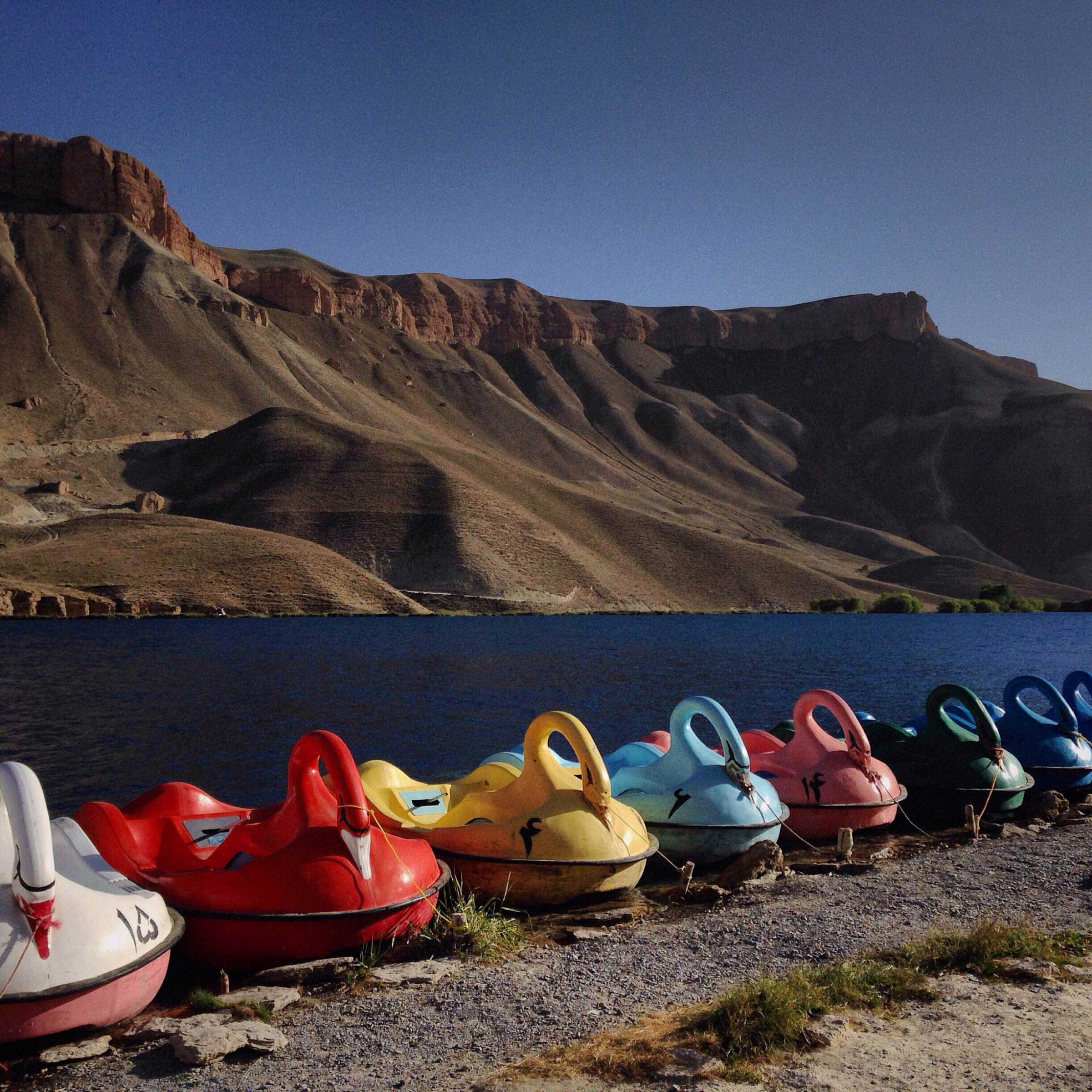 There probably isn't a person who comes to Band-e-Amir in Bamiyan Province that doesn't take this photograph. These paddle boats, rented for $6 (USD) as a foreigner and $3 as a local. The lake that they float on is an incredible azure blue- a color that seems completely incongruous in the windswept, high desert landscape. Taken in Bamiyan, AfganistanPhoto by Andrew Quilty/Oculi (@andrewquilty)