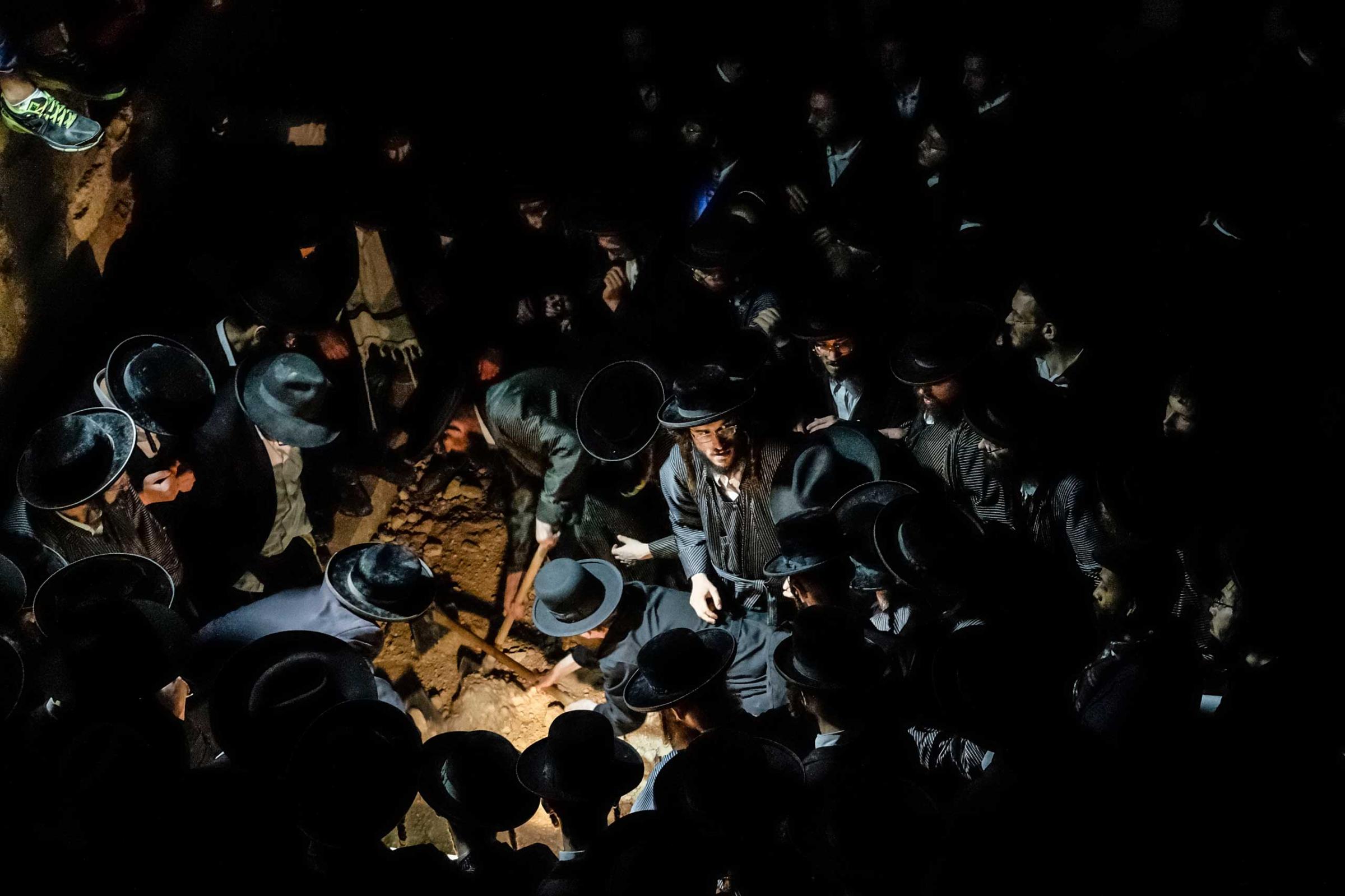 ISRAEL. Jerusalem. August 5, 2014. The funeral of Avraham Walz, 29, killed in an attack earlier that day by a Palestinian in a stolen digger.  Six Israelis were injured and the assailant, identified as Muhammed Naif el-Jaíabis.  Walz was a member of Toldos Aharon, a strongly Anti-Zionist Hasidic movement.