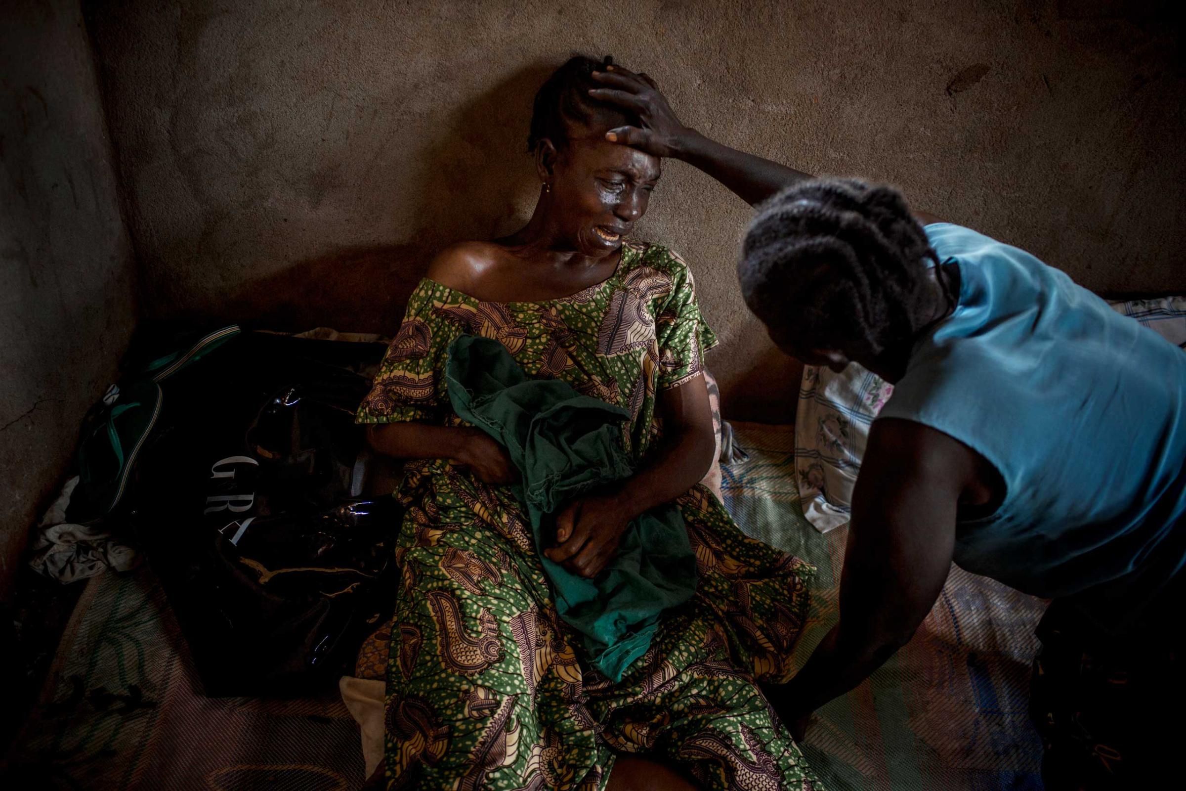 A woman cries the death of her 23 years old daughter Fleuri Doumana who was killed by a grenade launched in her courtyard by a member of the Seleka. The rebel group that took power in March 2013 carries out numerous exactions such as murders, kidnapping, torture.... Bangui.