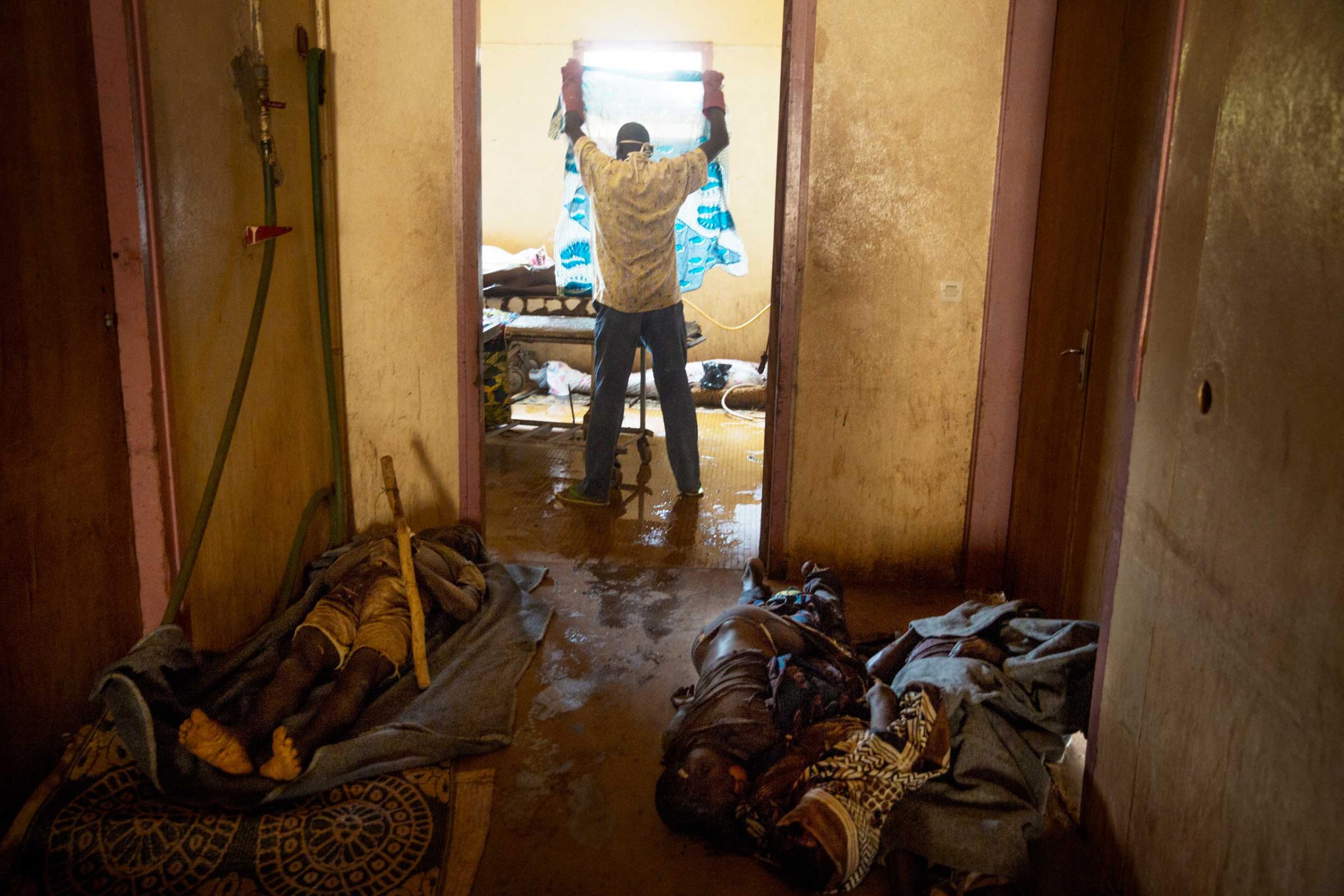 BanguiA man prepares a body for funeral at the morgue surrounded by Some of the dozens of bodies of Christians presumably killed by Seleka militia in revenge for attacks by Christian Anti Balaka militia on Bangui.