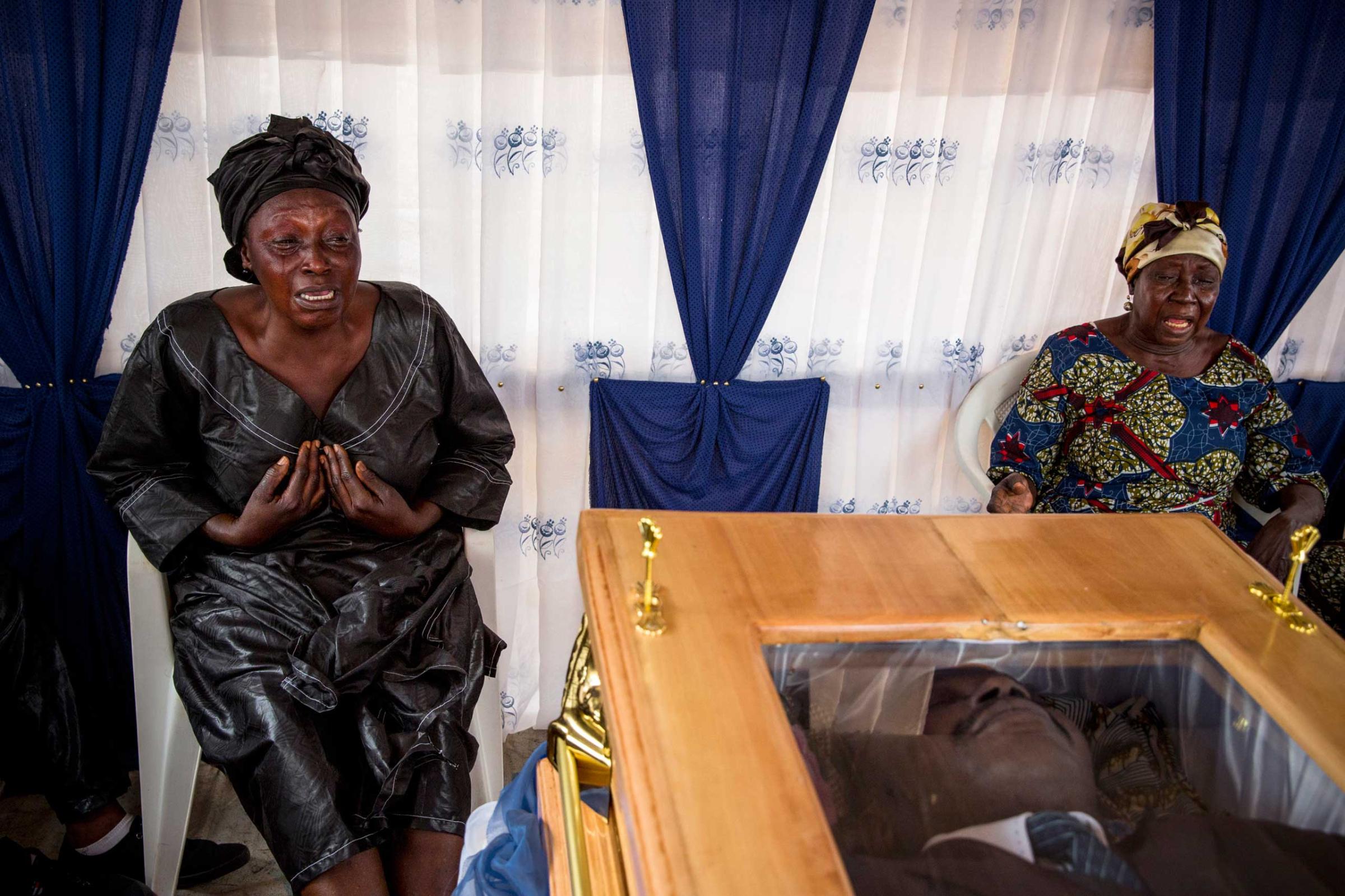 Central African RepublicBanguiRelatives touch the coffin at the funeral of Judge Modeste Martineau Bria who was killed by Seleka fighters in Bangui. The murder of Bria led to an outpouring of public anger at the reign of fear imposed by Seleka fighters who have refused to disband following the December 2012 coup against former president Francois Bozize.